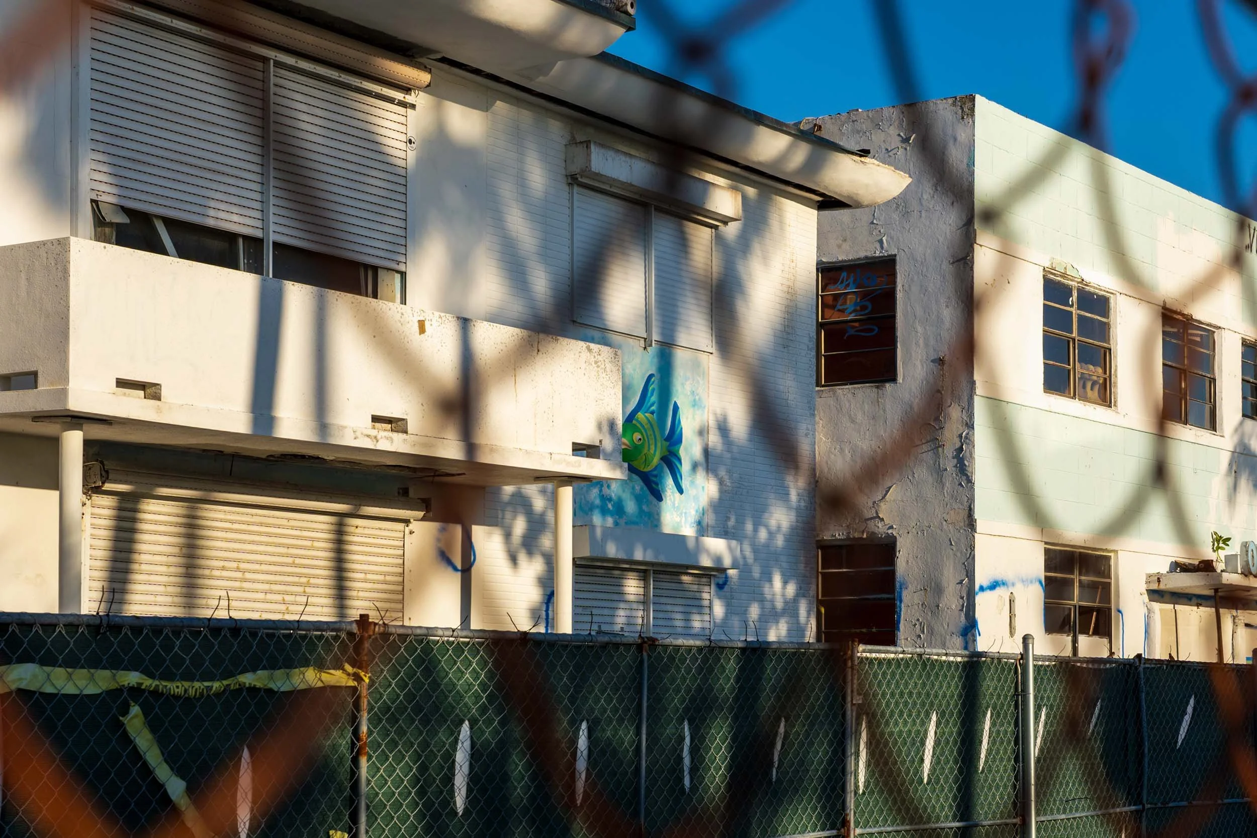 Ocean Terrace hotel building seen through construction chain-link fence, North Beach Miami