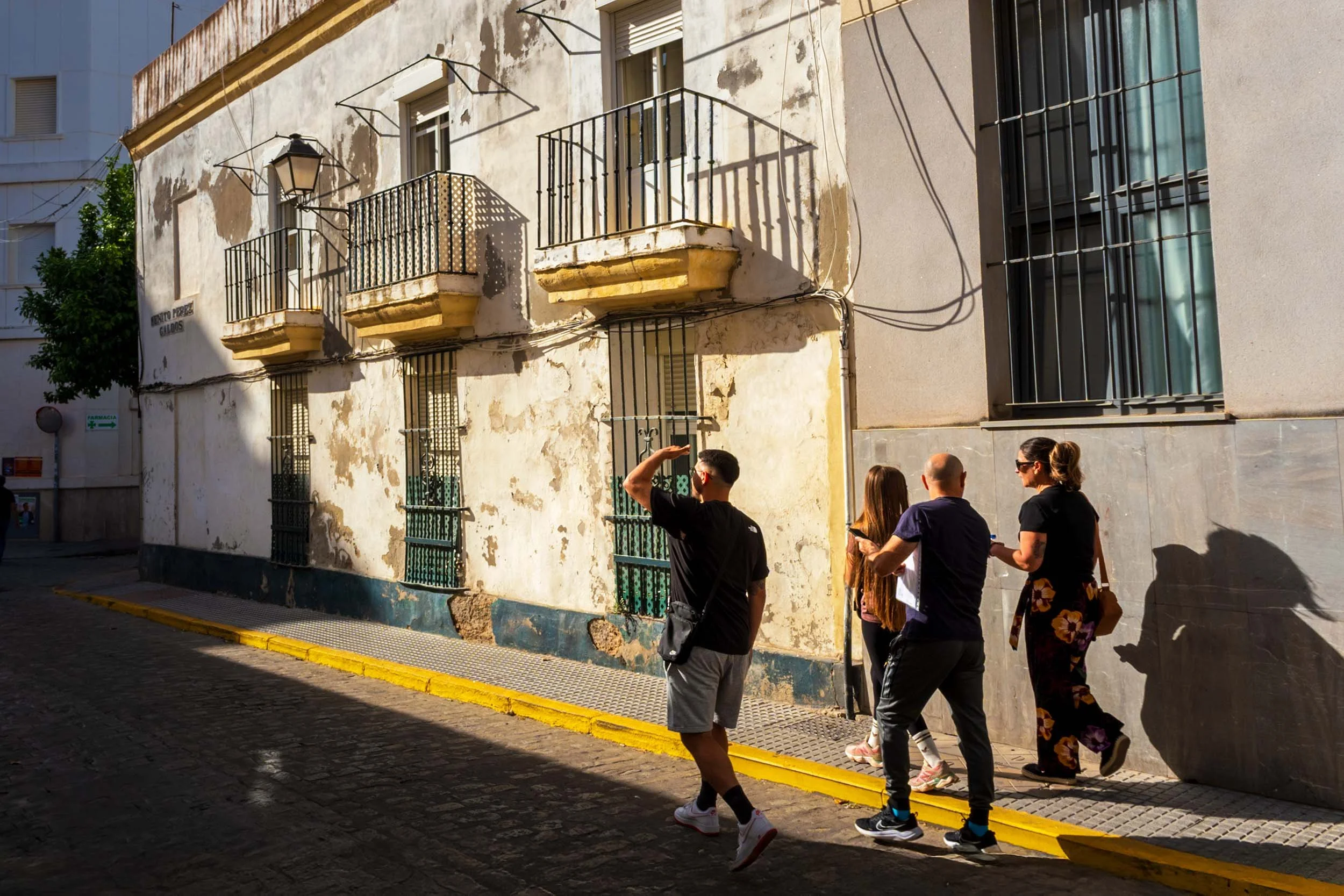 Cadiz Spain old town street photography historic building iron balconies tourists exploring Andalusia