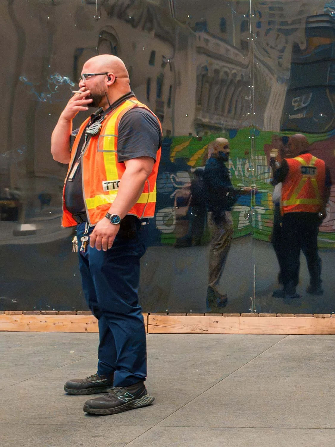 TTC transit worker orange hi-vis vest smoking break Downtown Toronto urban street photography