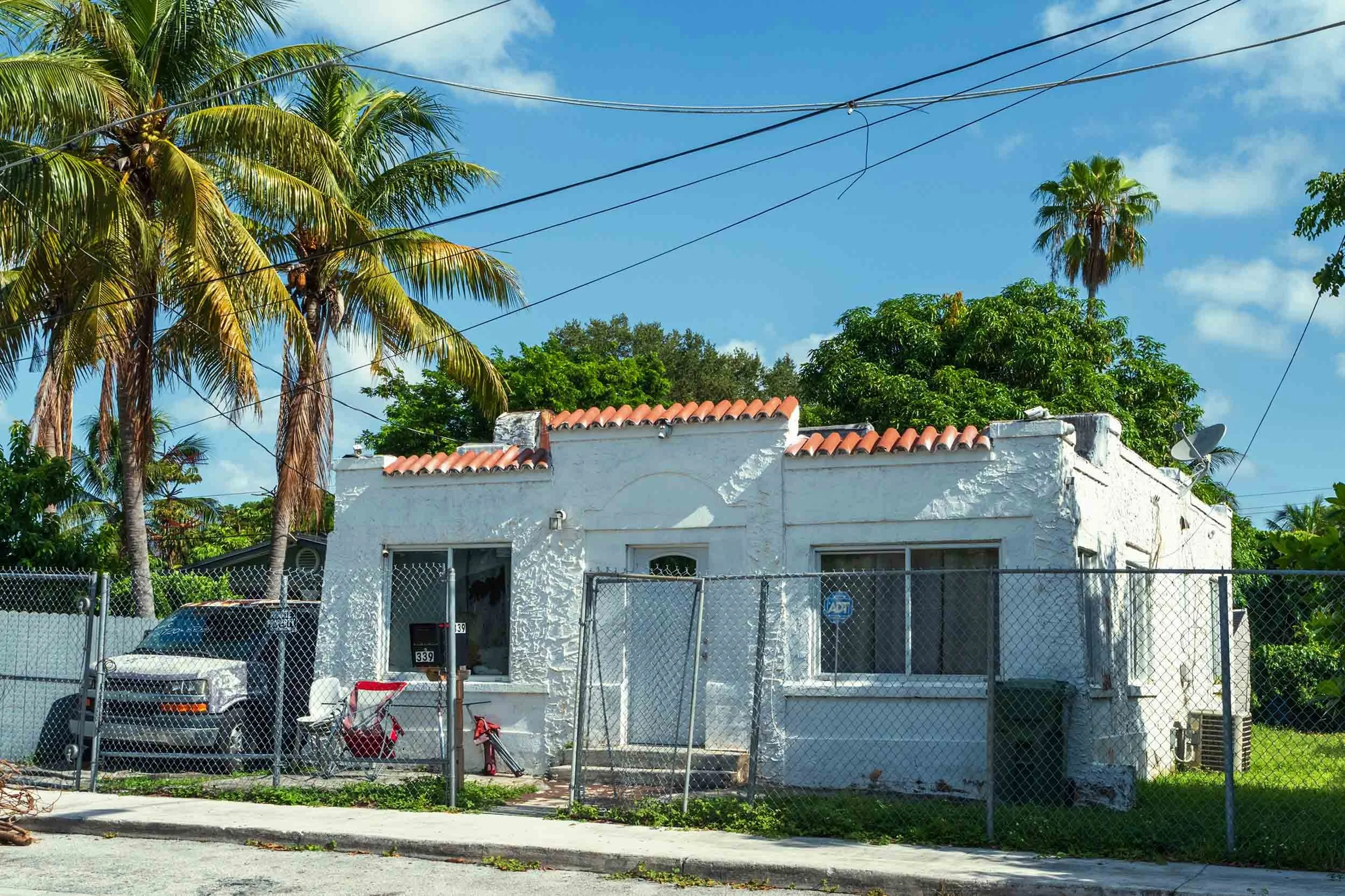 White stucco Mission-style home with red tile roof