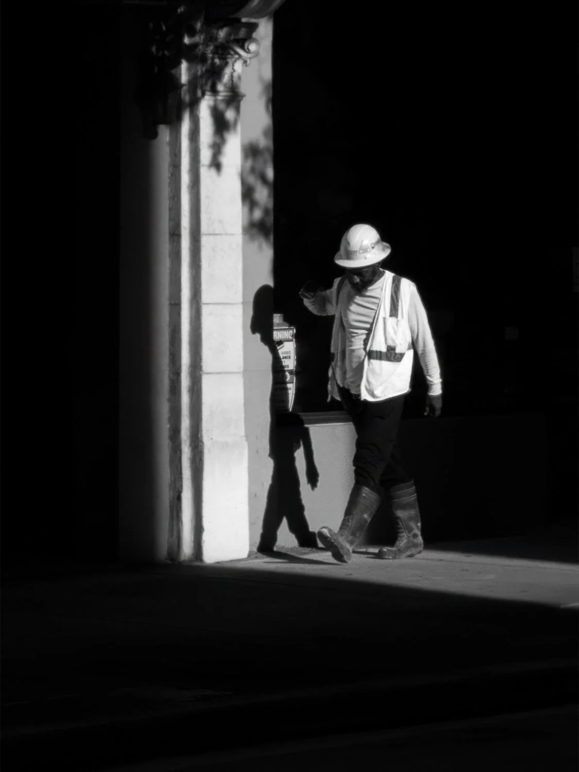 downtown Miami construction worker hard hat safety gear urban black and white street photography architecture shadow