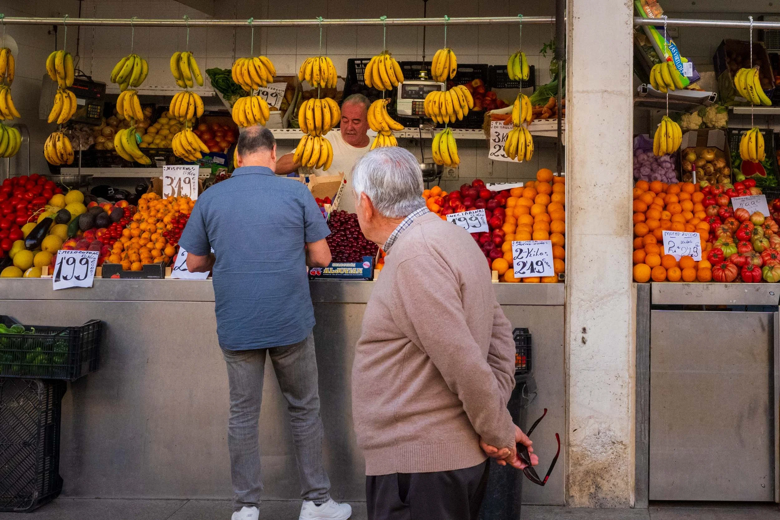 Cadiz Spain fruit market stall fresh produce bananas oranges local vendor traditional Spanish mercado street market