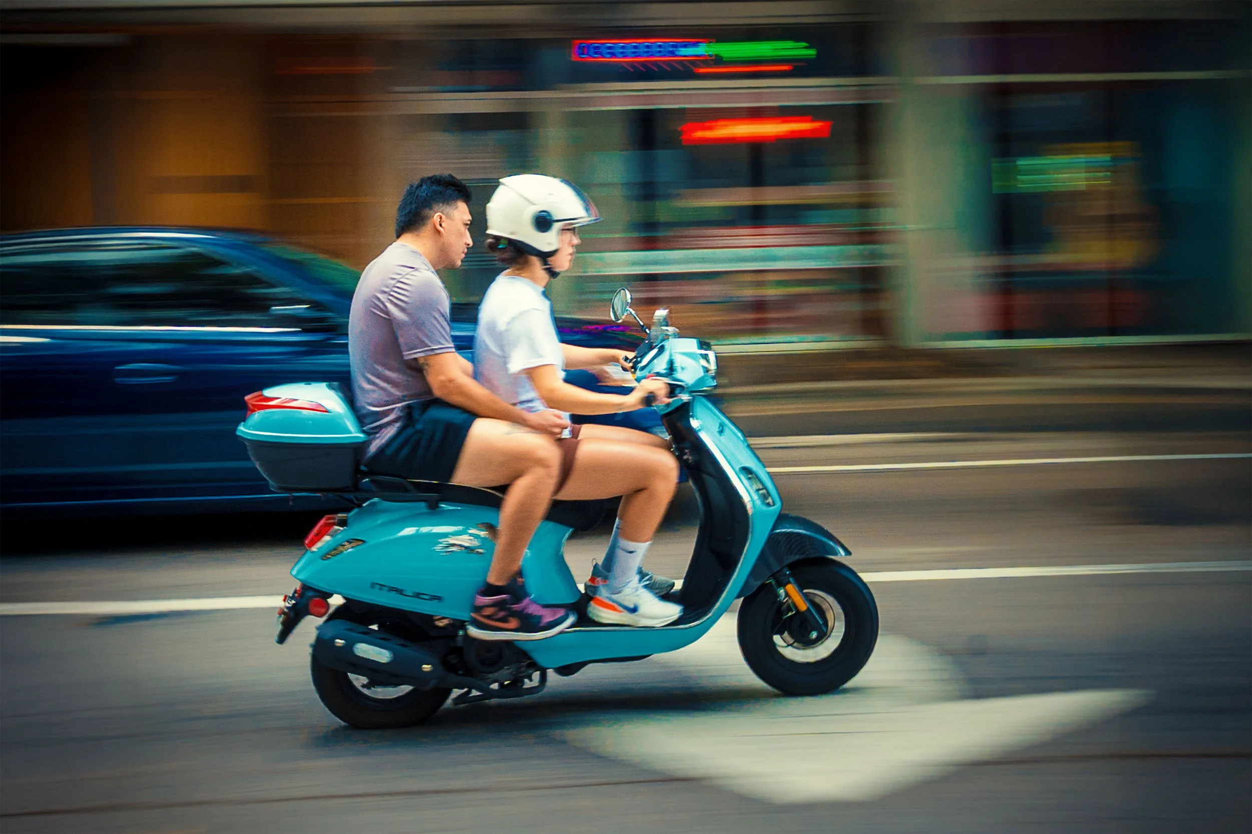 Panning shot of a motor scooter in downtown Miami