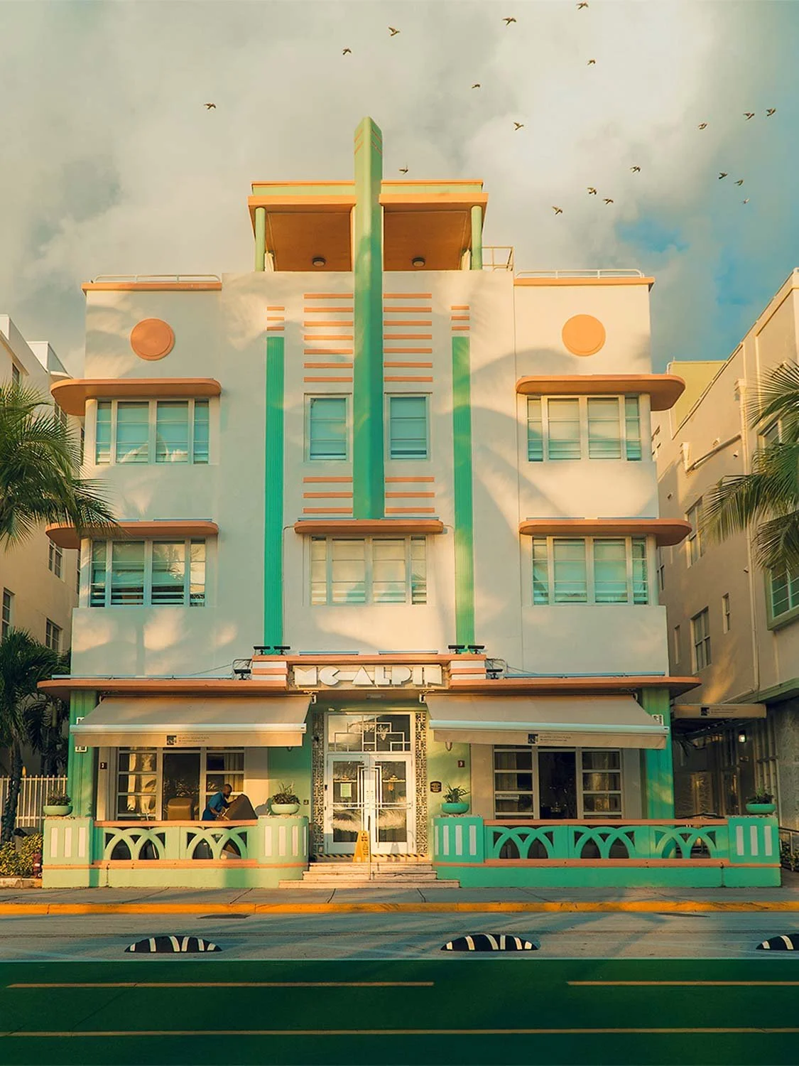 ption 4 (SEO-focused) Morning light creating shadows on an Art Deco hotel on Ocean Drive in South Beach Miami, showcasing pastel architecture and classic design.