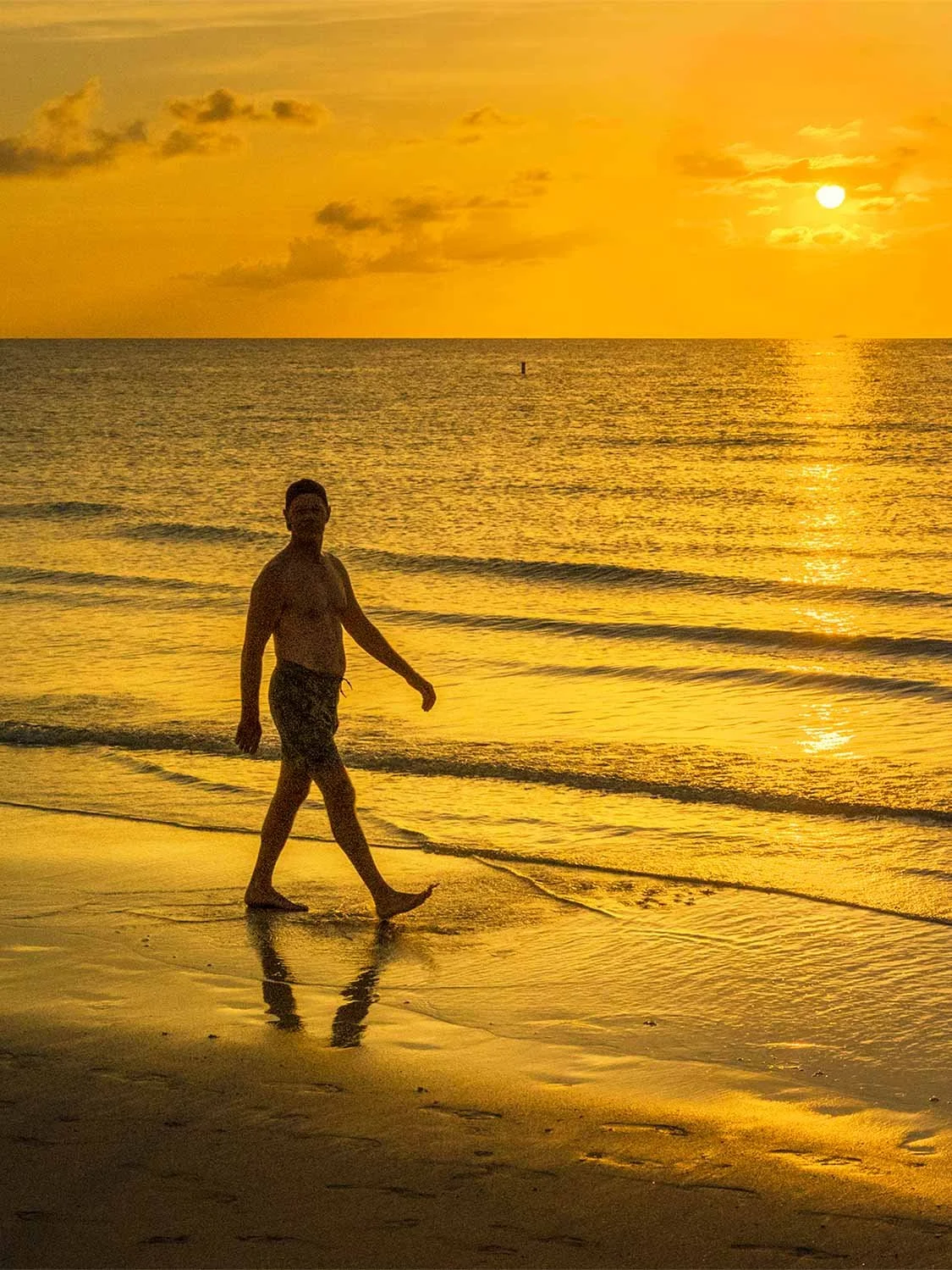 South Beach sunrise beach walk man shirtless golden hour ocean waves Miami morning lifestyle photography