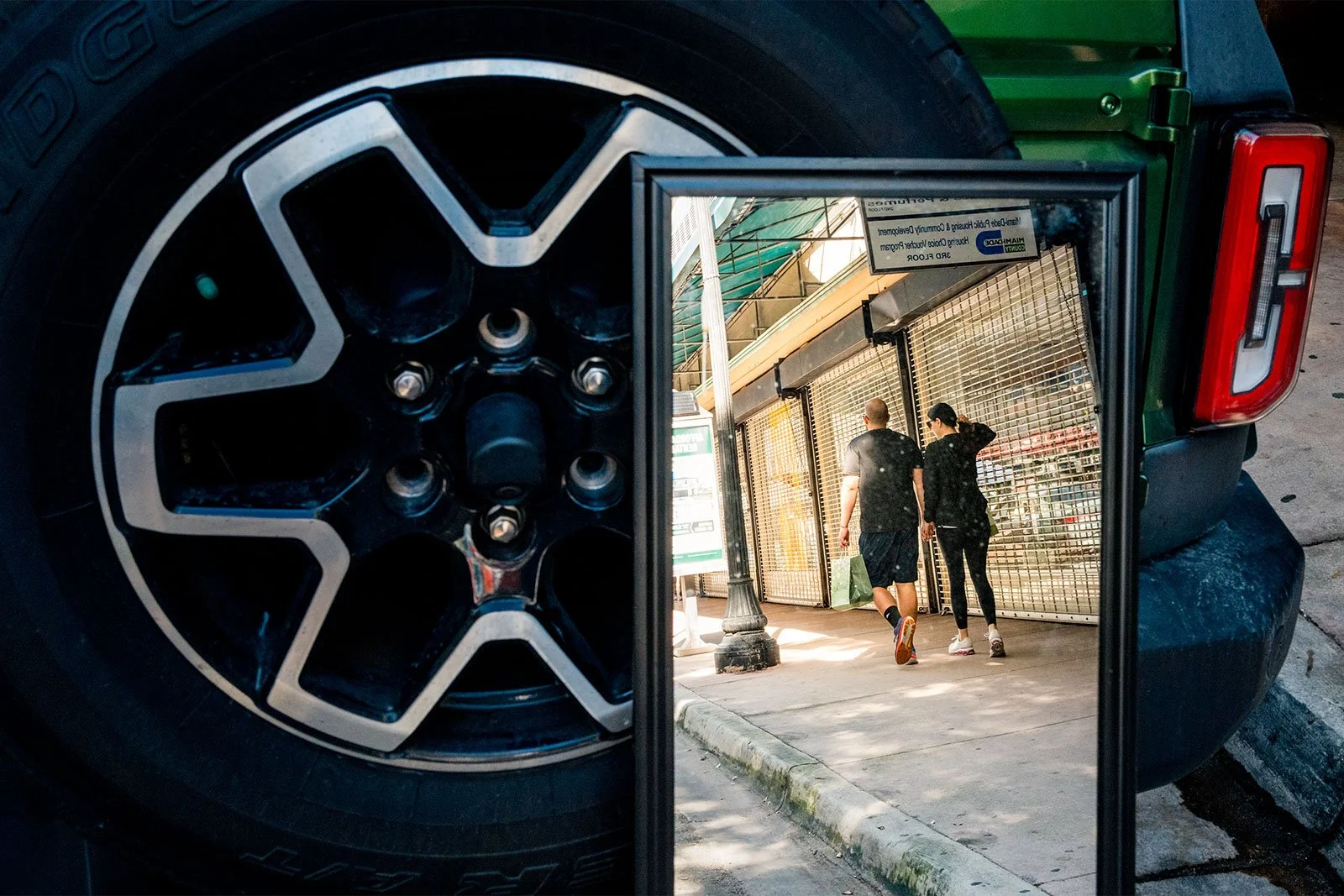 Street photographer uses a mirror in downtown Miami to create a frame within a frame