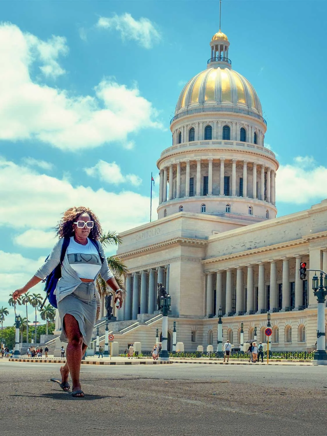 Havana Cuba travel El Capitolio landmark woman tourist golden dome architecture Caribbean