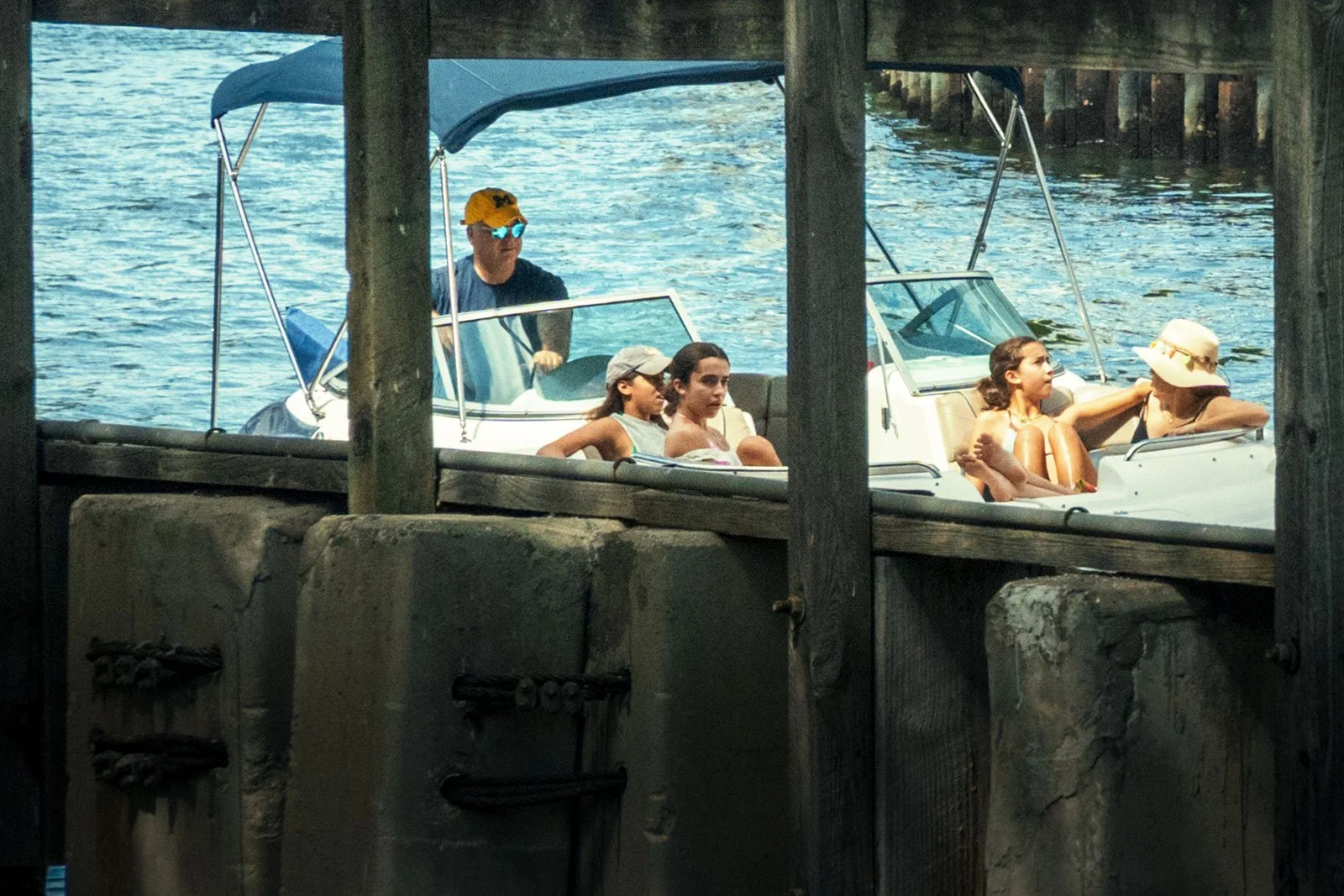 A family cruises down Miami River past Brickell Avenue on their boat
