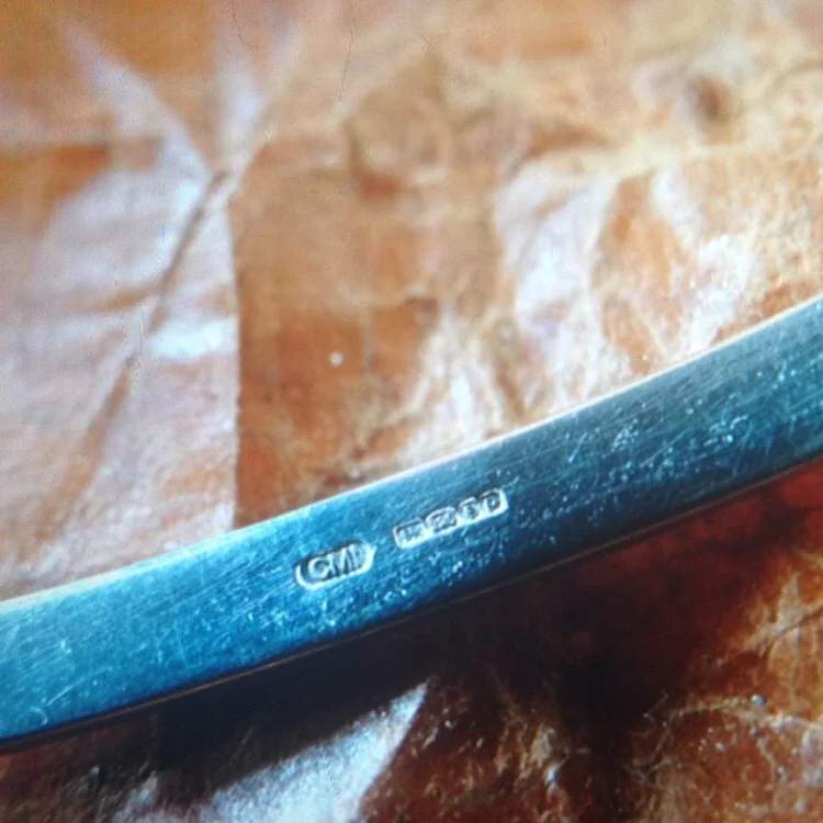 CMI maker's mark along with the year and assay hallmark