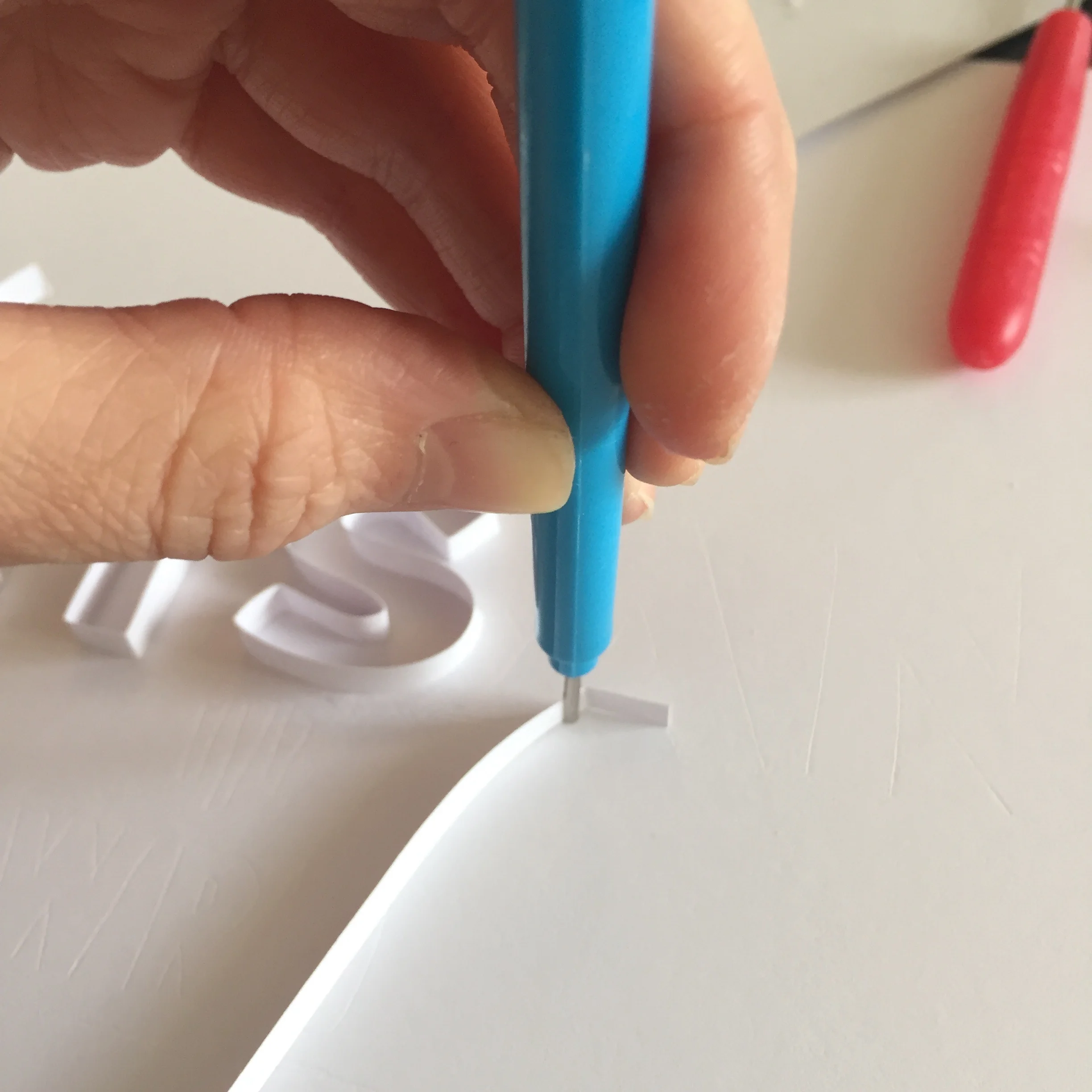 Tool slots paper in the gap and it can then be bent to an angle