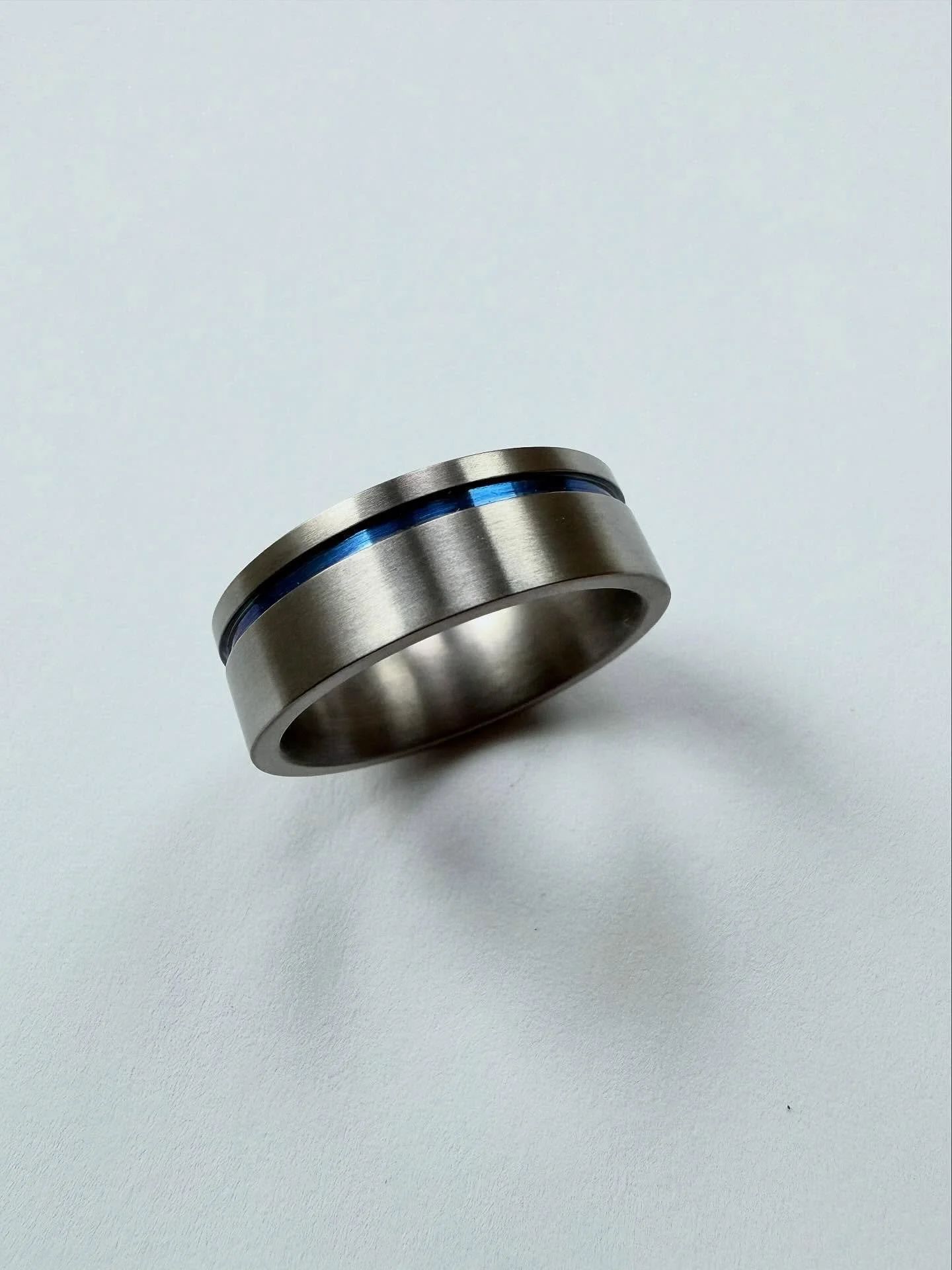 Titanium ring, anodised with a blue indent