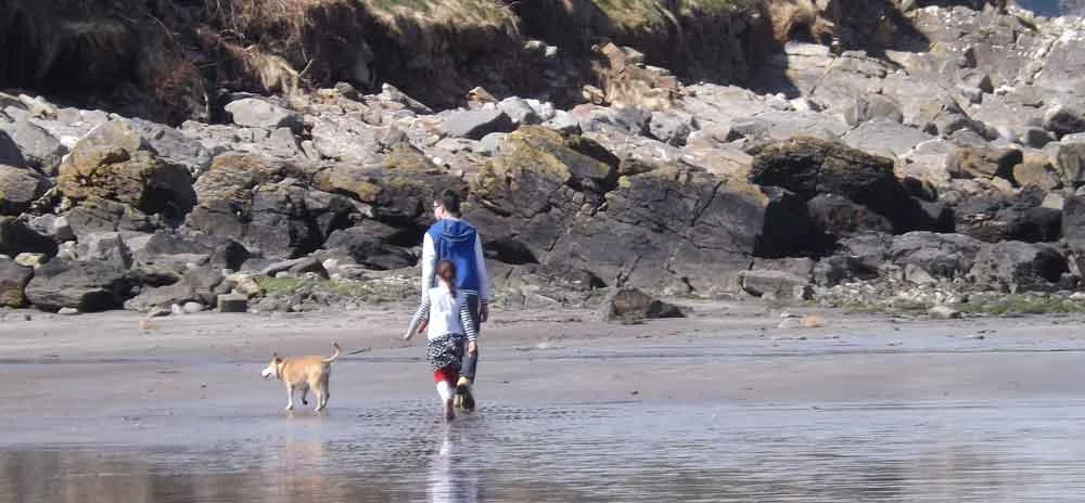 Willow the dog leads Will and Emma the humans.