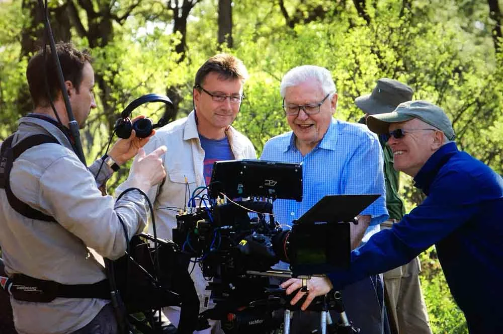 Wildlife film-maker, producer, author and qualified zoologist Dr Paul Stewart (in the middle; here with Sir David Attenborough and other team members) will be at TetZooCon 2019. Image: (c) Paul Stewart, used with permission.