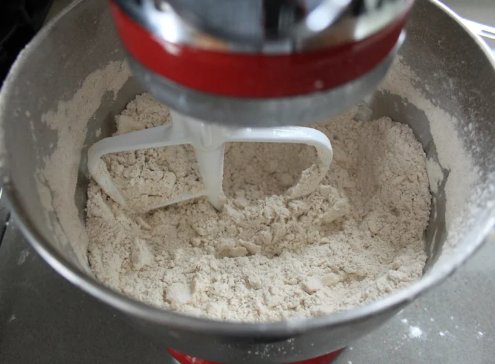 When the butter is mixed in, it should be a course mixture with the butter in pea size chunks.
