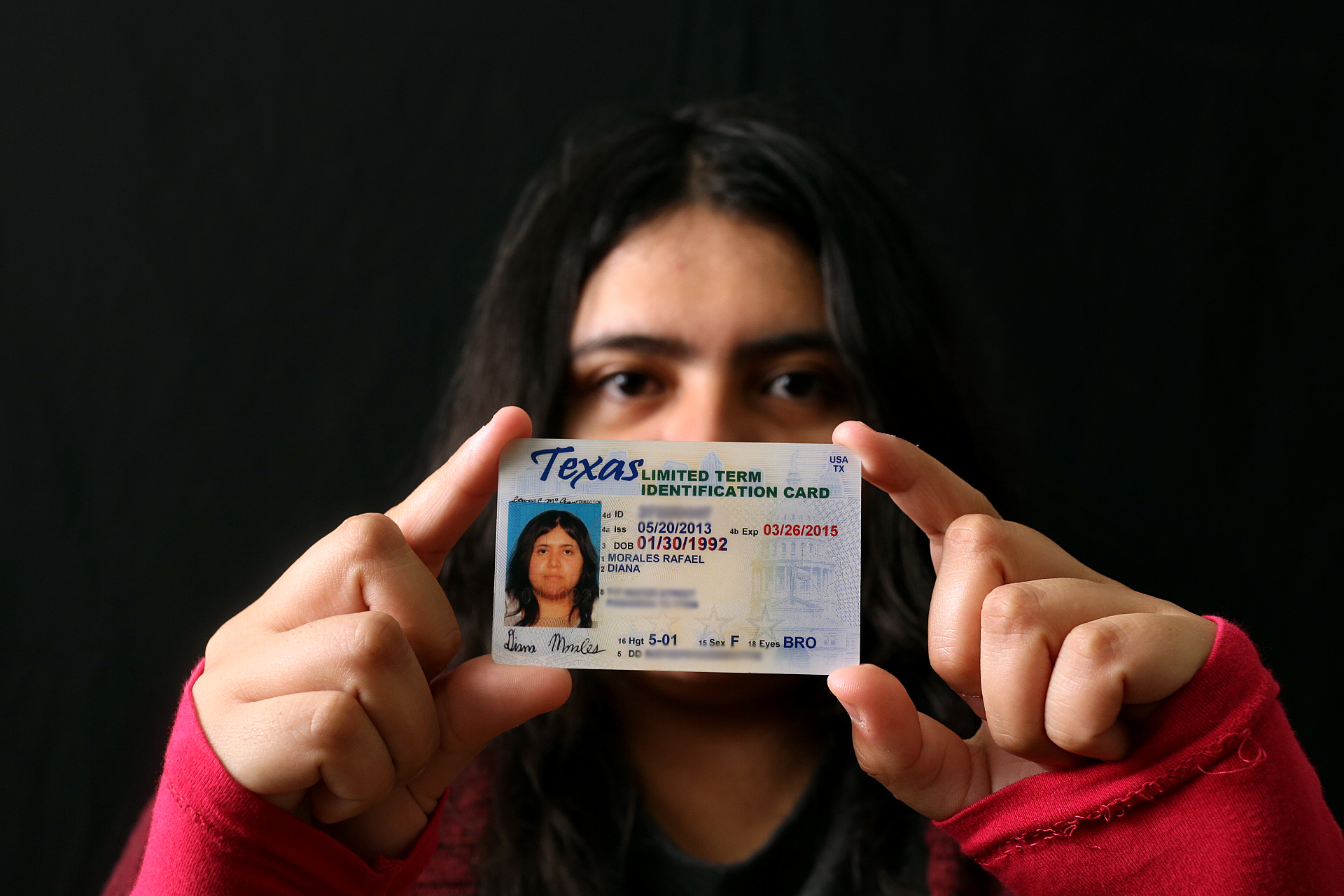 Diana Morales, sophomore at University of Texas at Austin, holds the state identification card she received through the federal deferred action program. She is one of 72,400 undocumented immigrants in Texas who have won temporary legal status through the program.