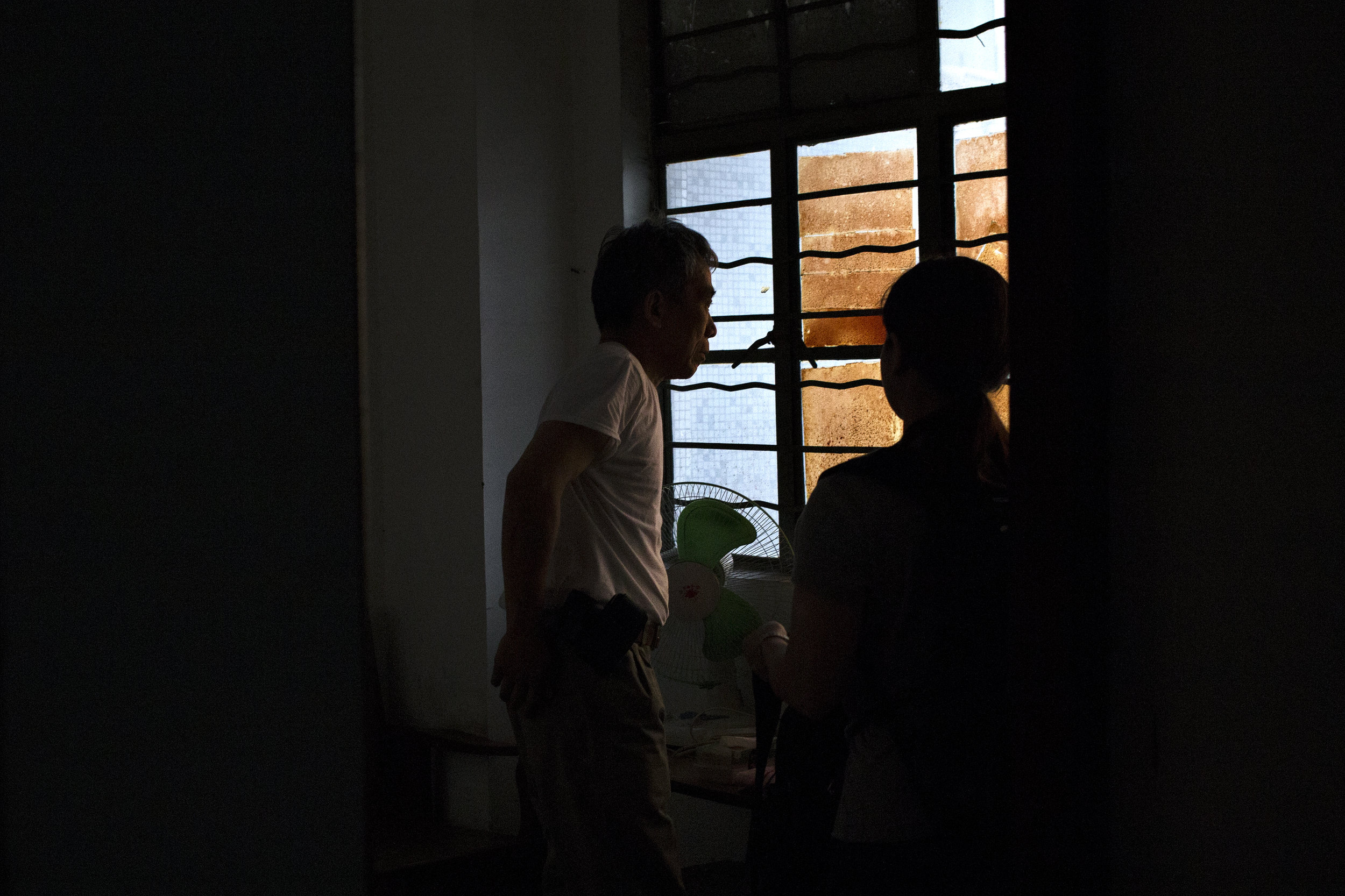 Father gazes through the window after being woken from a nap by Mother. “It’s time to go,” she says. 