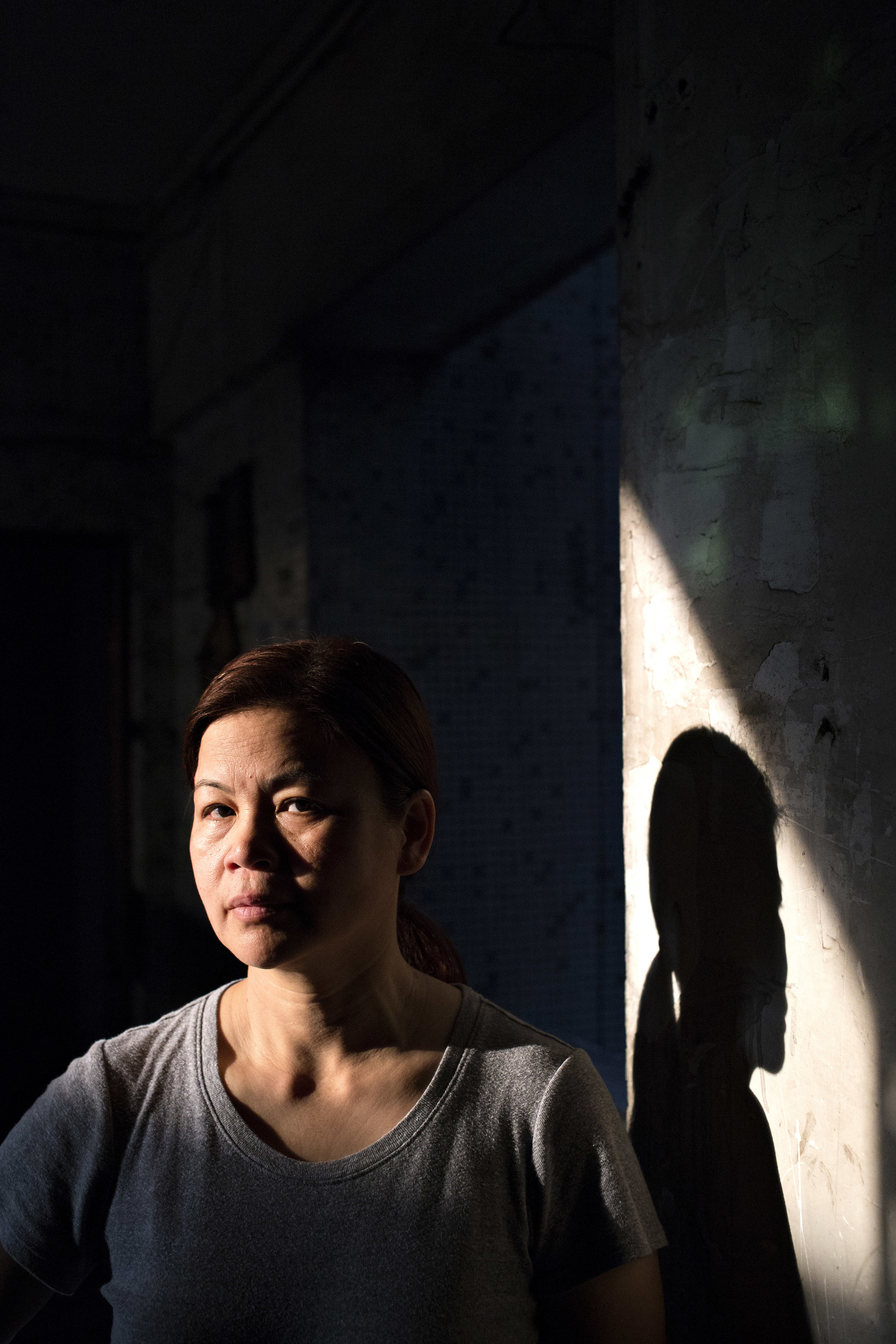Mother poses for a portrait taken outside the apartment. 
