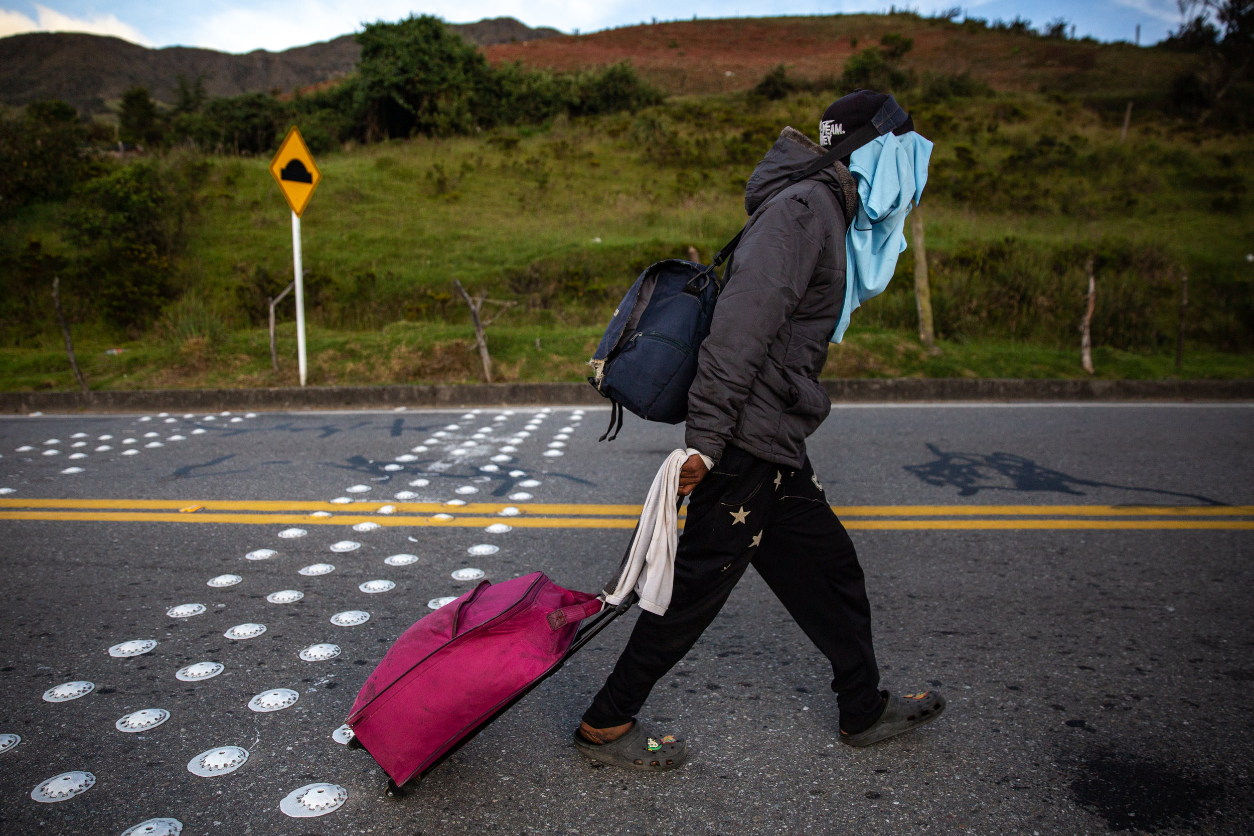 Luis Lugo, 19, wears what clothing he has to protect himself from the cold wind and unfiltered sun of the high mountains.