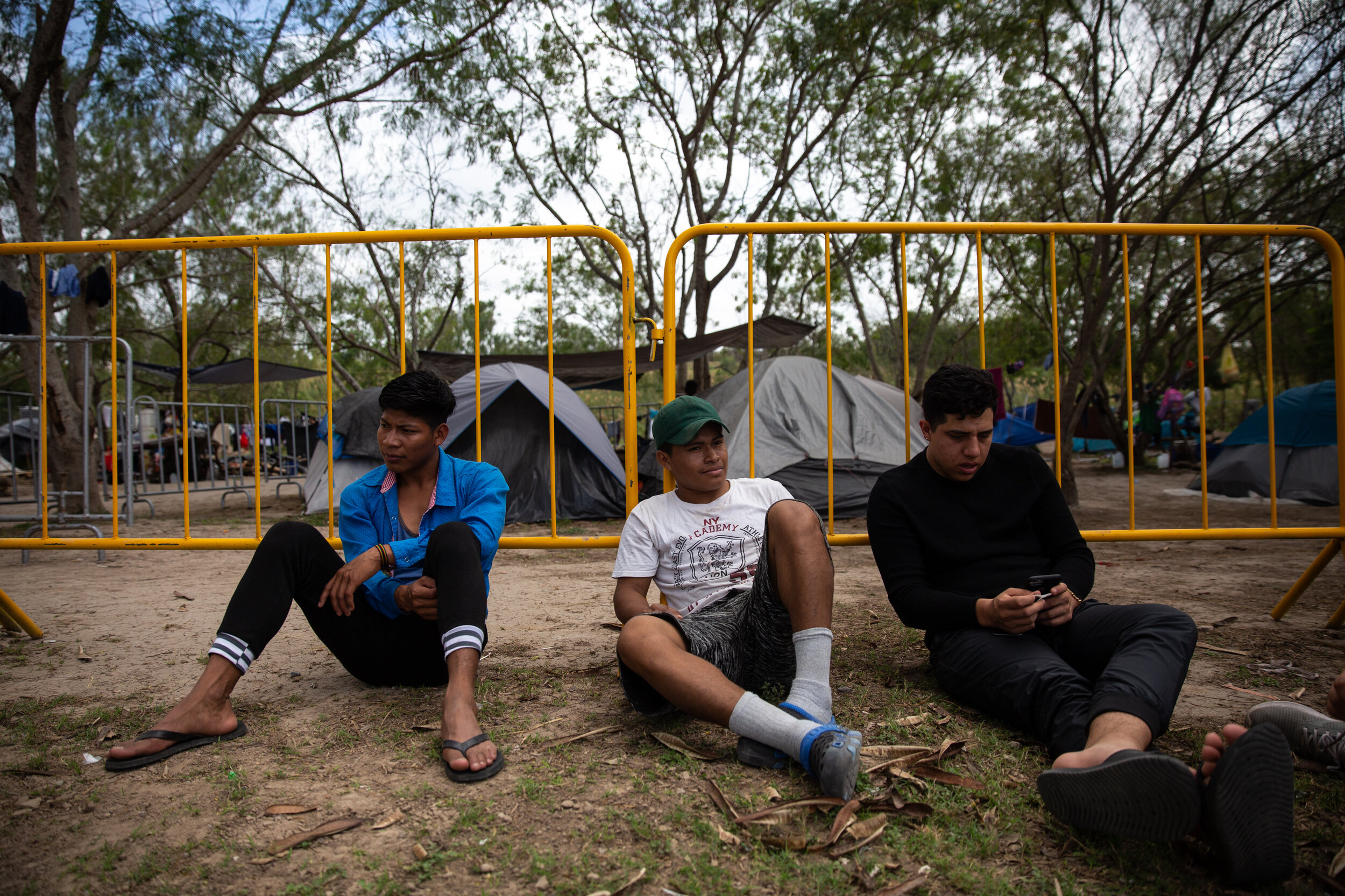  Mynor Emilio Cruz, Jose Jonathan Carrillo and Damian Meza take a break from constructing the new 'comedor' or dining hall structure at the migrant camp in Matamoros, Mexico.  
