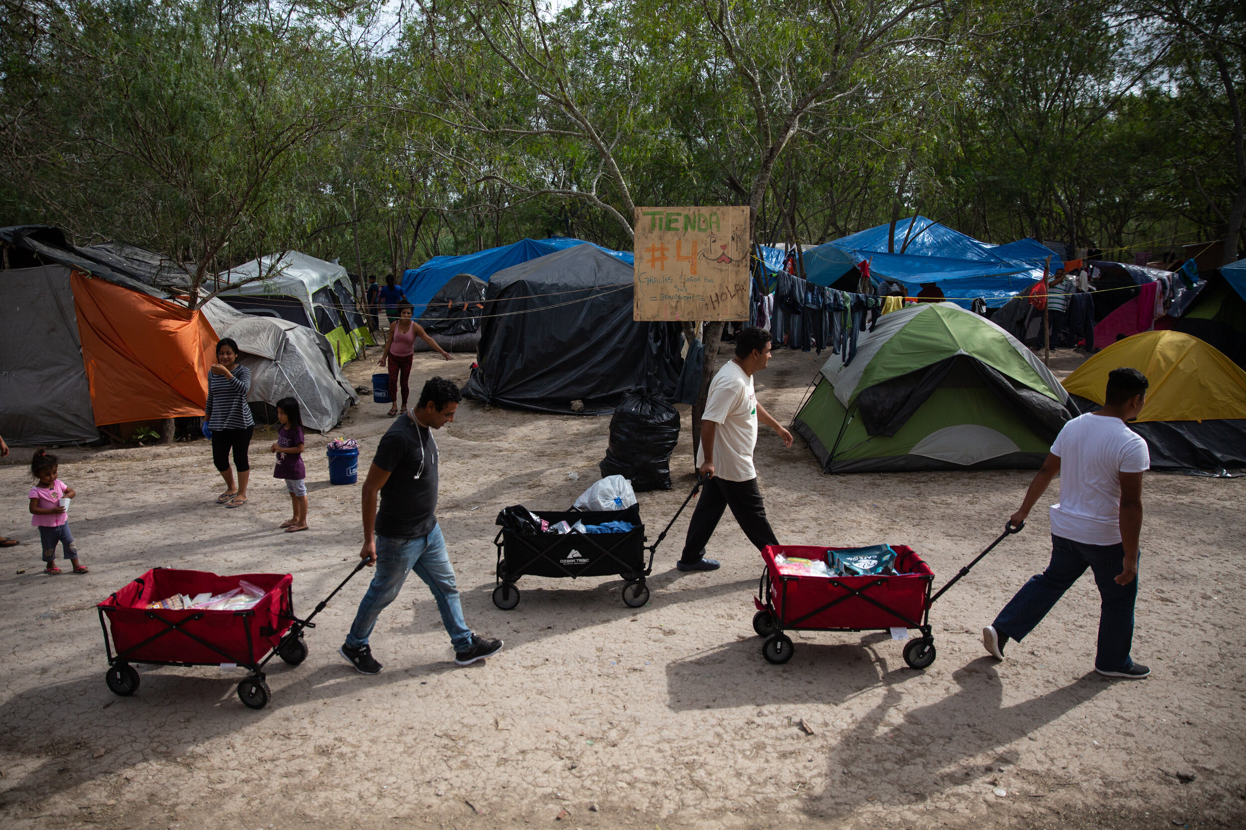  Donations brought over the border from volunteer group Angry Tias and Abuelas are wheeled into the Matamoros migrant camp on Jan. 15, 2020. The encampment relies almost entirely on the efforts of volunteer groups and religious charities for food, te