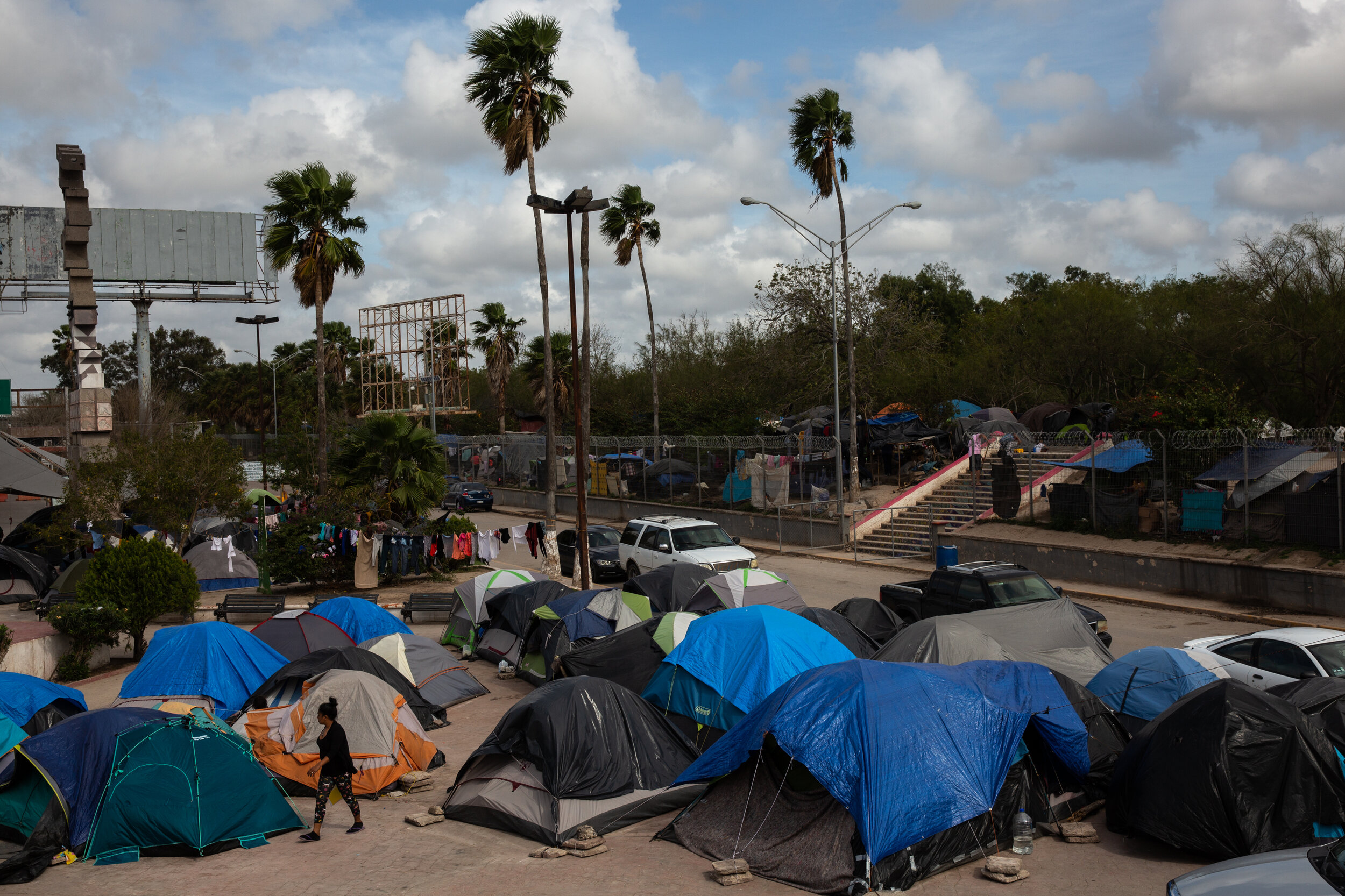  A makeshift encampment near the border houses migrants  in Matamoros, Mexico. As part of Migration Protection Protocol (MPP) migrants are forced to wait months for their asylum cases to be processed while remaining in Mexico — a shift from previous 