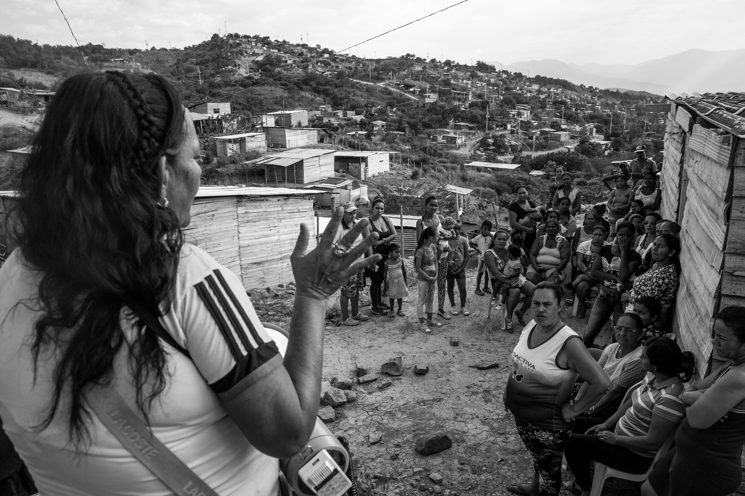  Sonia Pimento, leader of the Alfonso Gómez community, holds a meeting to share news of NGOs coming to offer training in domestic violence and leadership.  Pimento assumed leadership after seeing a need to organise the newly arrived families looking 