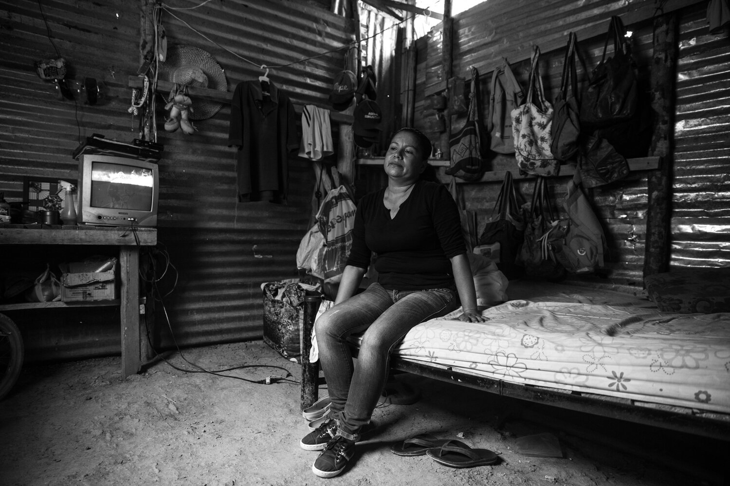  Zoraida Espinosa, 41, sits inside her tin-roofed home, surrounded by personal belongings neatly stacked and arranged.  Over time in Venezuela, the food ran out, the medicine ran out, and she ended up in Alfonso Gómez. “I don’t see the possibility of