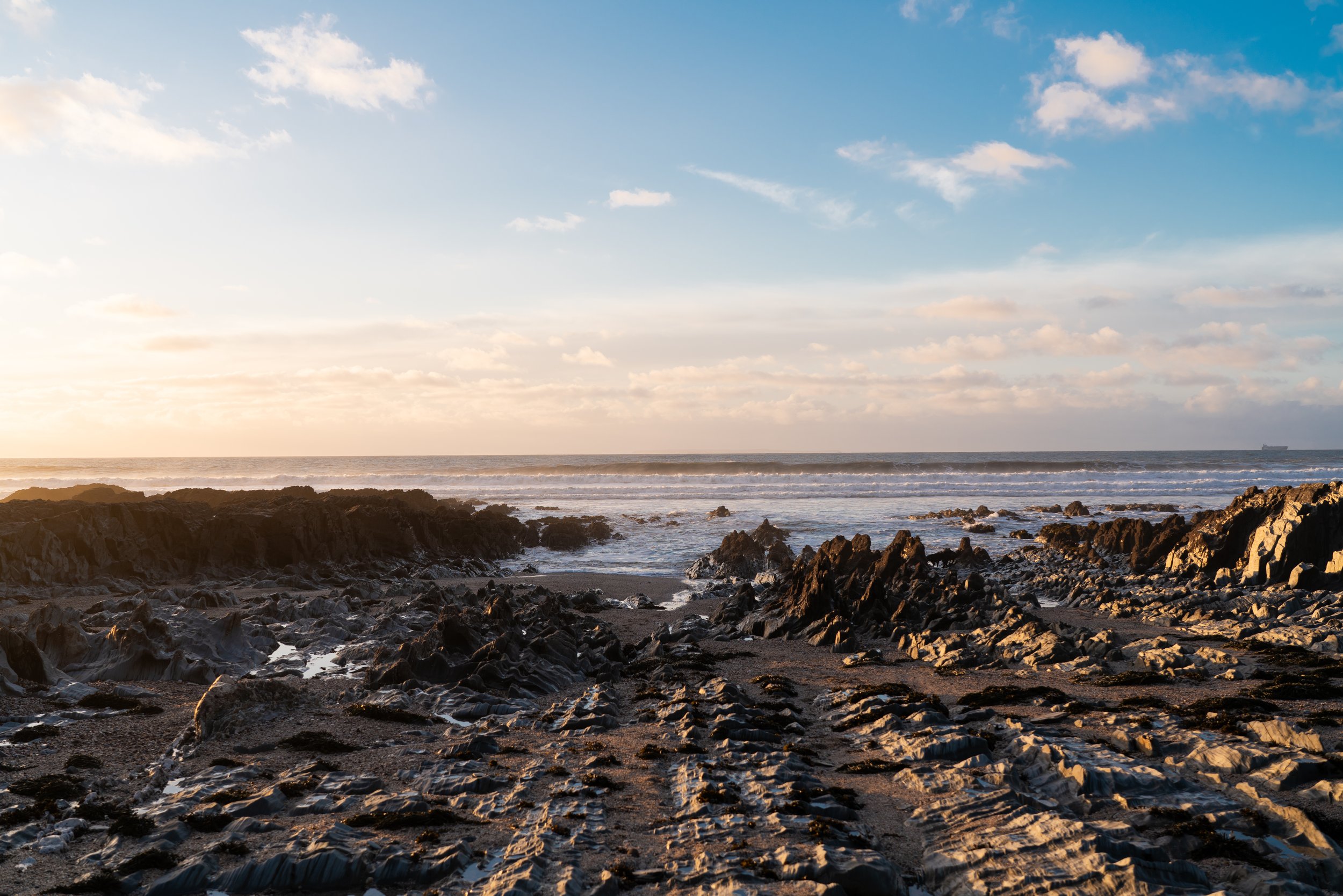 2025-12-12_rocky-beach-with-white-surf-line.jpg