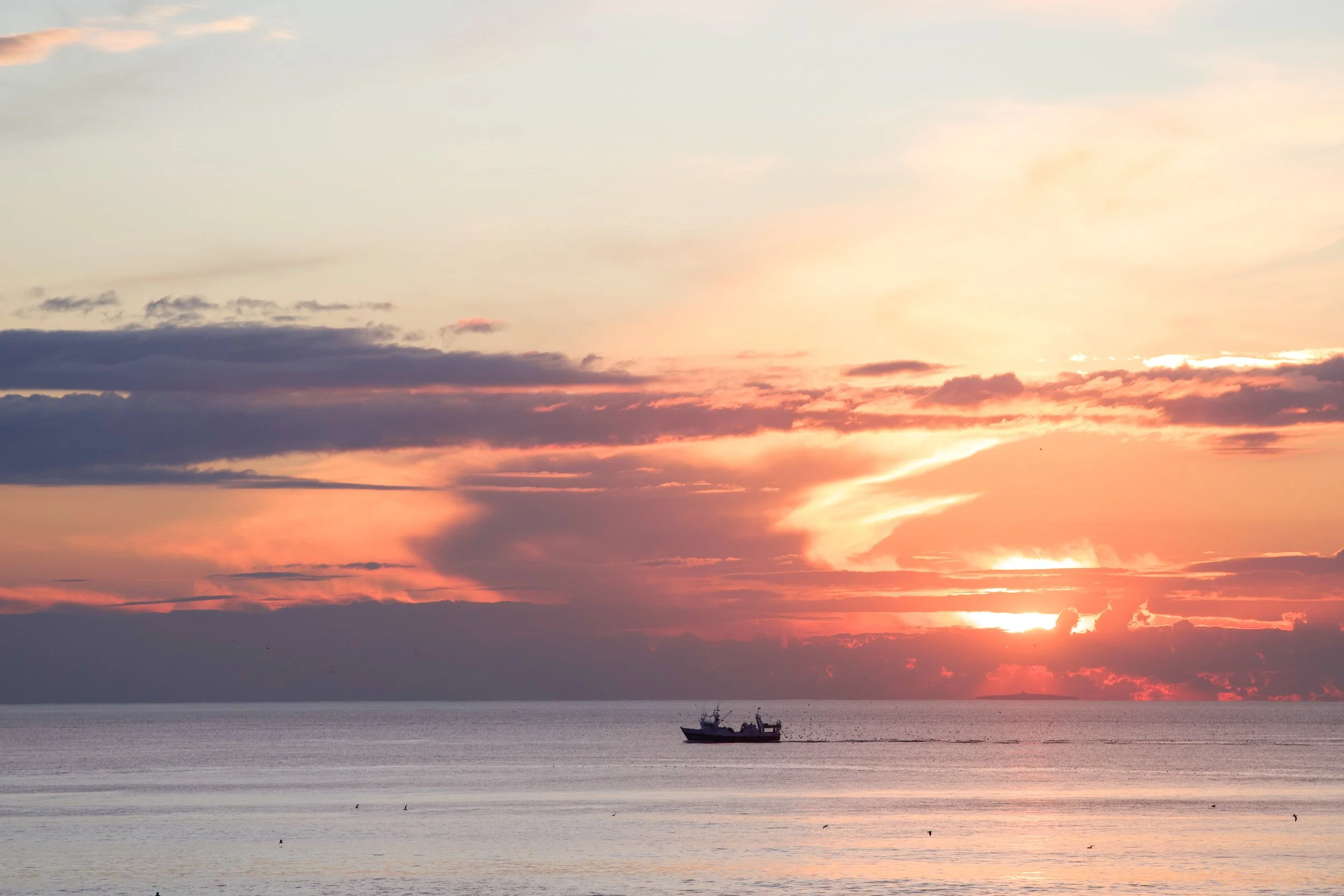 2025-02-10_fishing-boat-silhouette-at-sunset.jpg