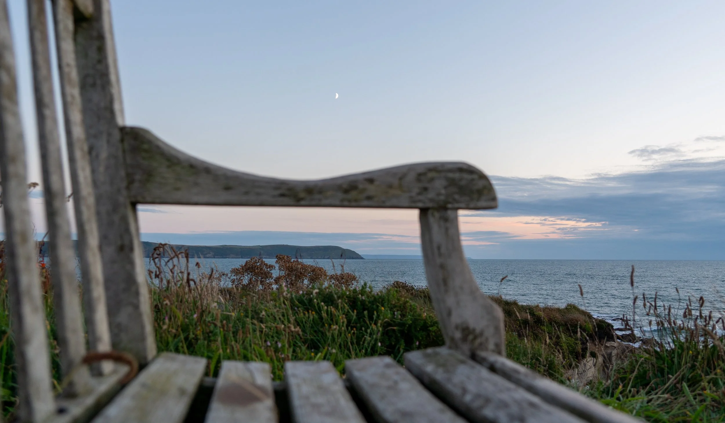 2025-08-01_bench-back-with-distant-moon-and-headland.jpg