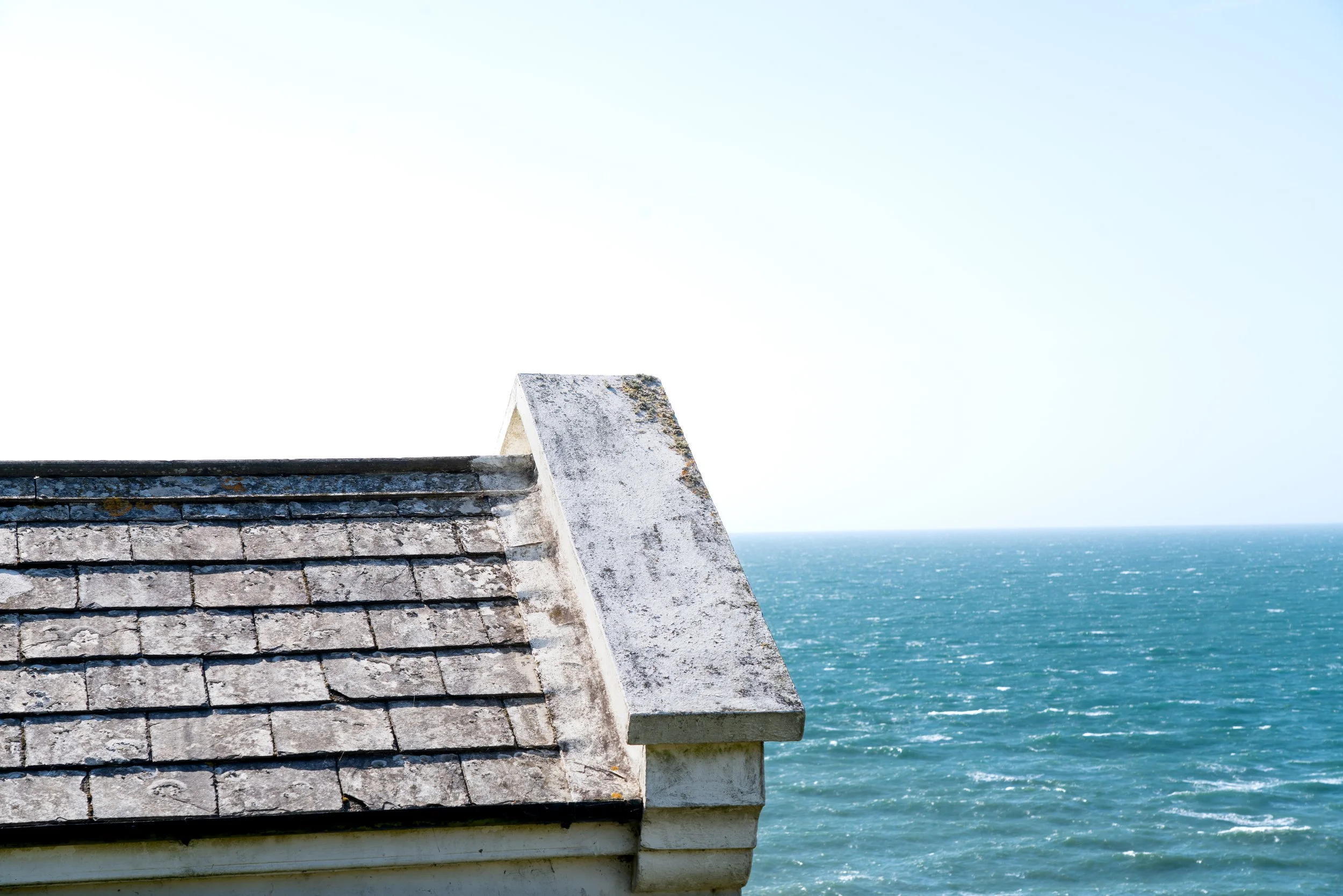 2025-08-04_slate-roof-against-blue-sea.jpg