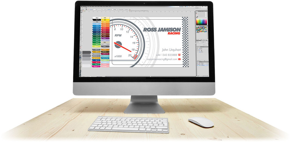 An iMac on a desk. On it's display is the artwork for a business card created as part of the free design service