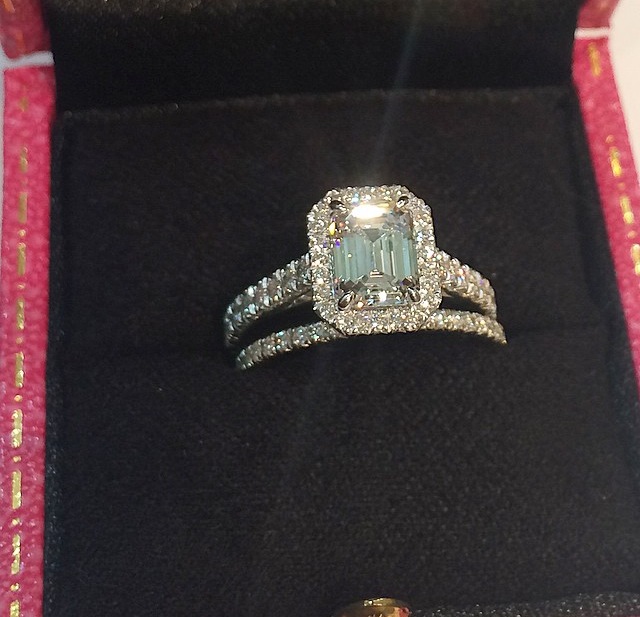Look at how the light reflects on the step-cut facets of this stunning colorless emerald cut diamond. The round brilliant diamond halo is the perfect contrast. Feminine, timeless + sophisticated. 