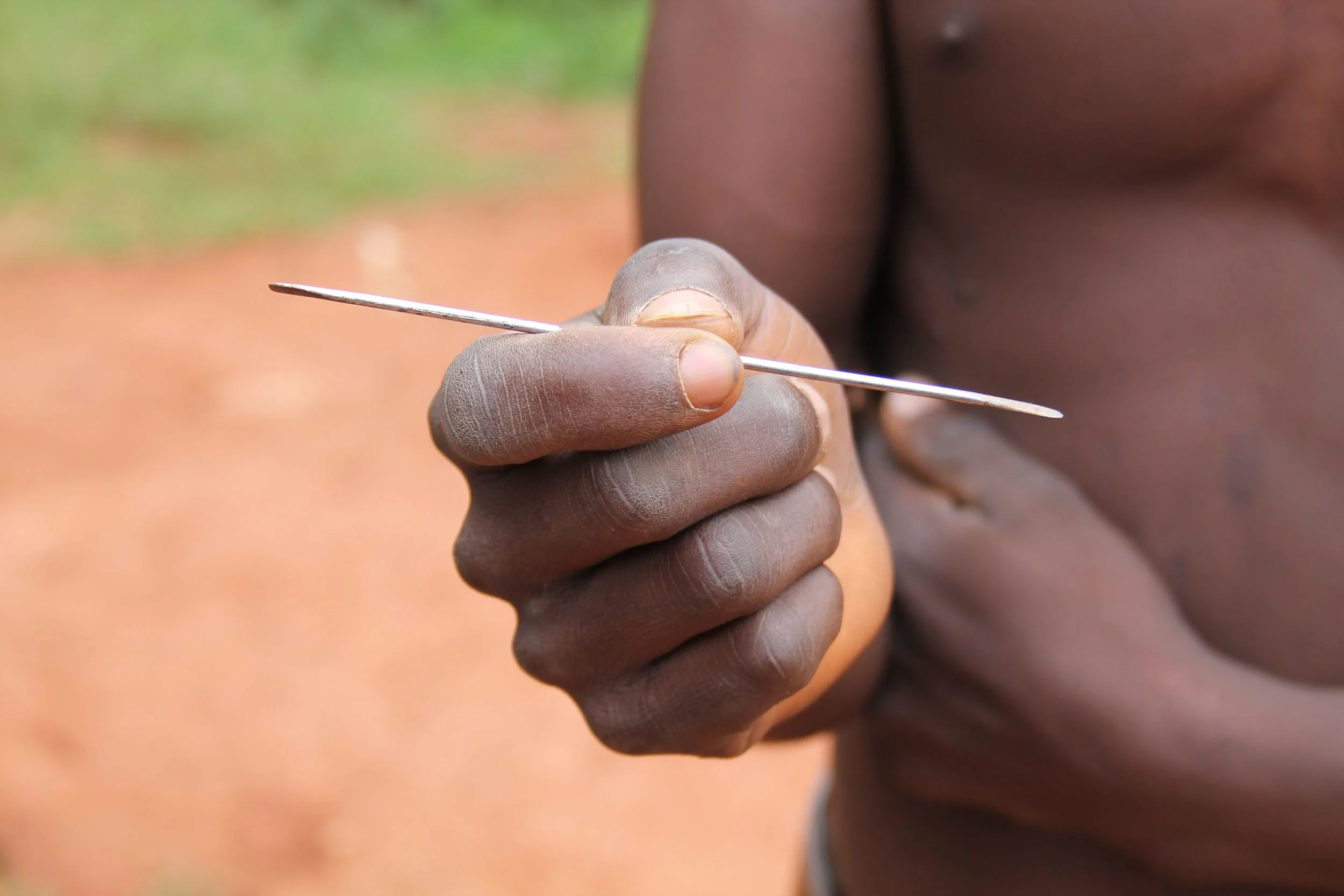 After cleaning off the dried blood. Nahayo's son shows me the flattened bicycle spoke used for tooth extractions.