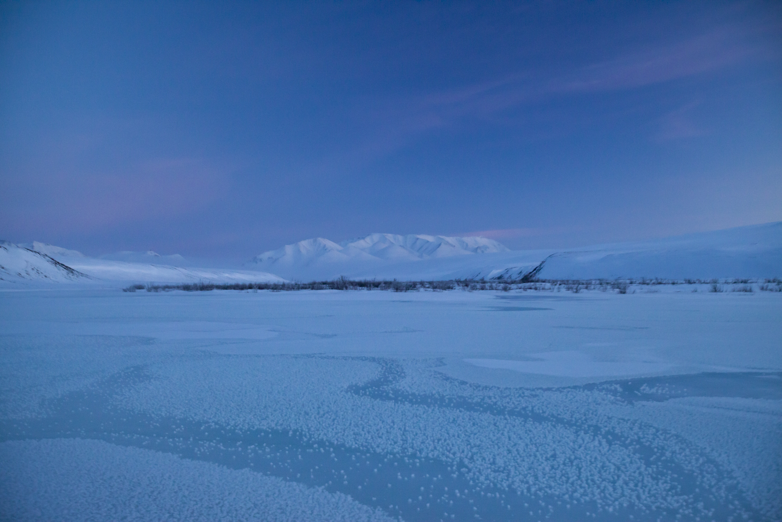 Overflow ice on the Hula Hula River looking from the Coastal Plain toward the mountains of the Brooks Range.