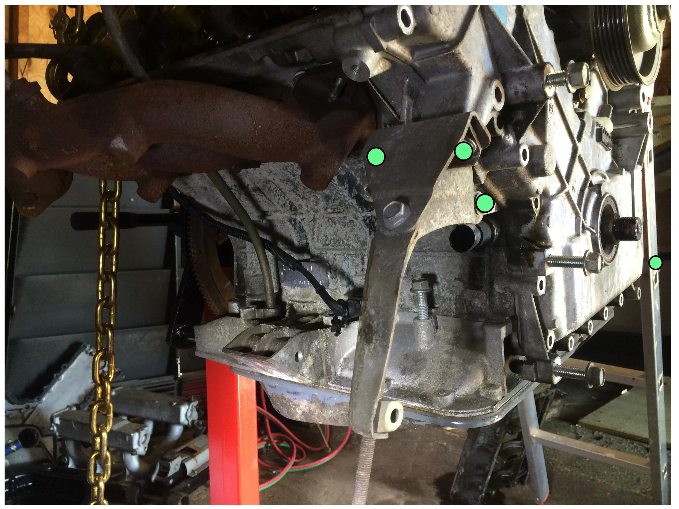 These three bolts (green, 13mm socket) secure a bracket to under the driver's side cylinder head.