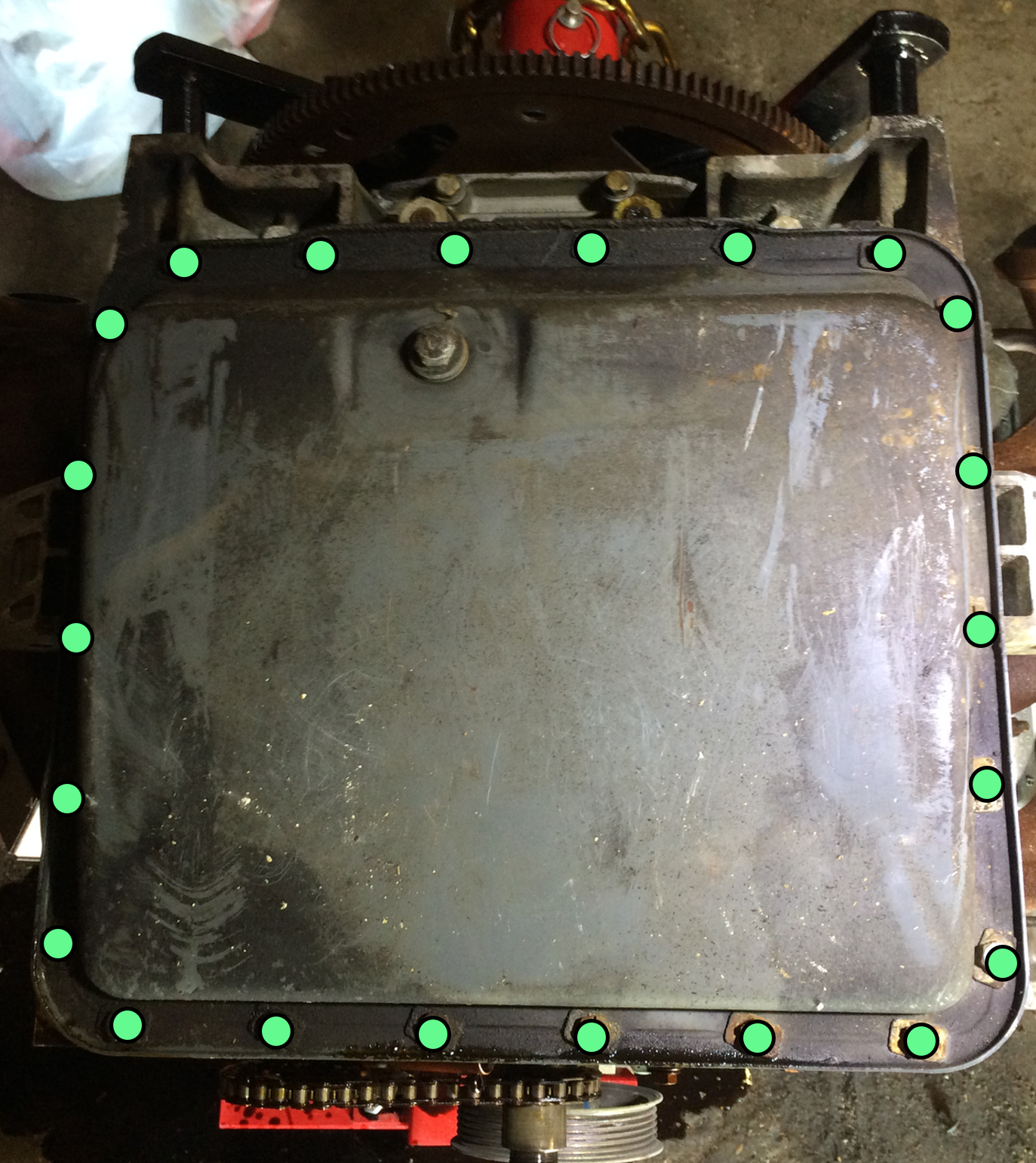 An 11mm socket can be used to remove the twenty two (22) bolts (green dots) holding the oil pan to the lower crankcase.