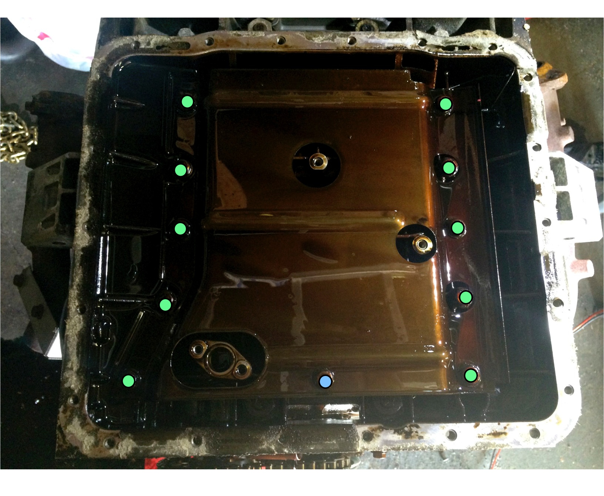The green dots mark the bolts removed with a 13mm socket, while the bolt represented by the blot dot takes an 11mm socket.