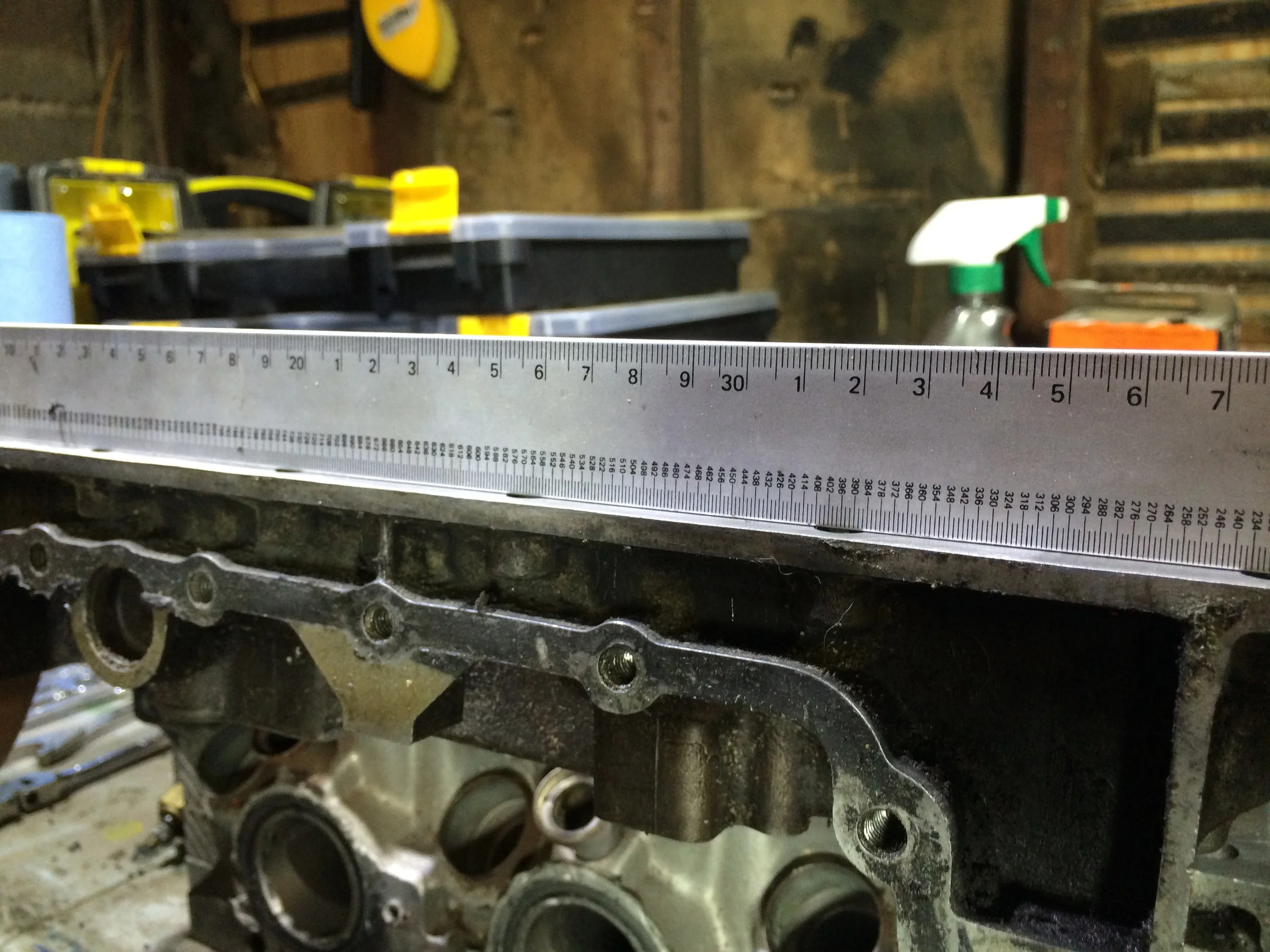Using a straight edge to test for depressions and low spots from the large amount of force I used to remove the gaskets with the bristle disc.