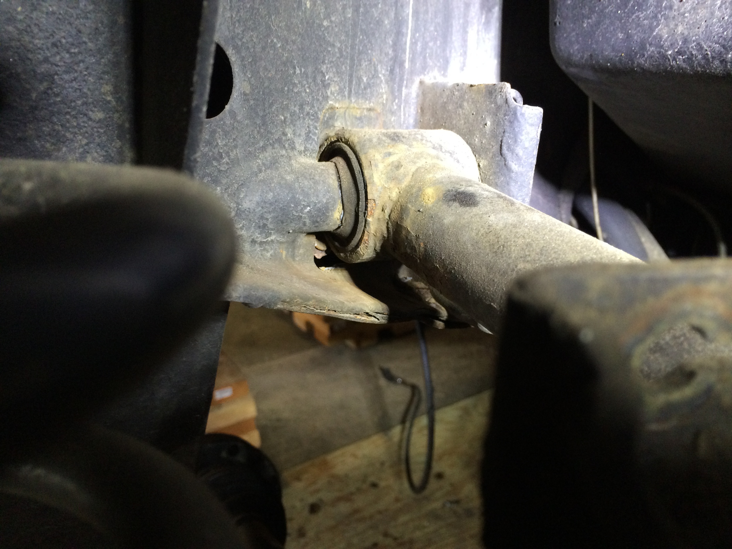 From the outside, the hole is visible just under where the link arm meets the frame.
