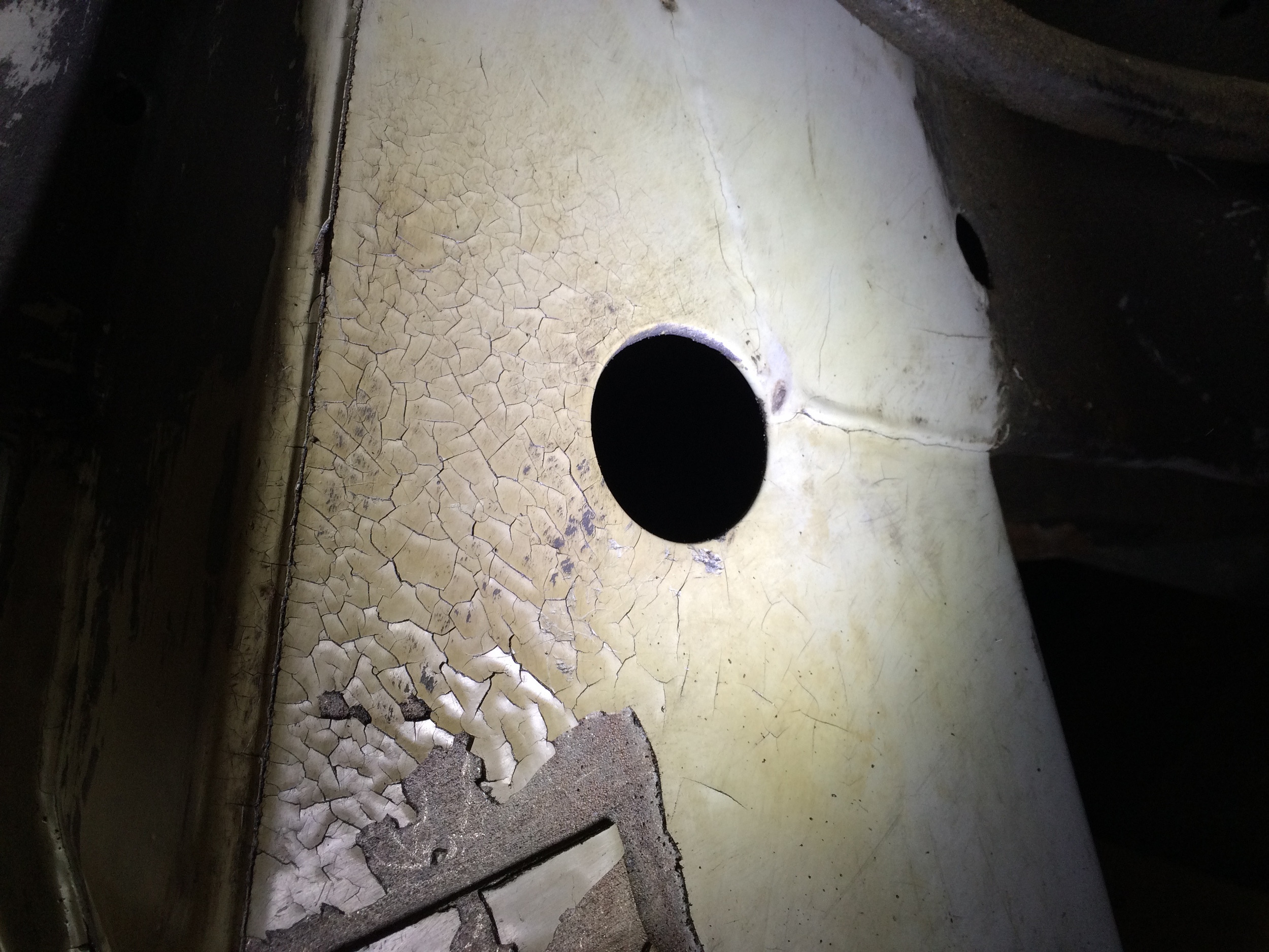 Small cracks along the surface of epoxy on the driver's side of engine cradle.