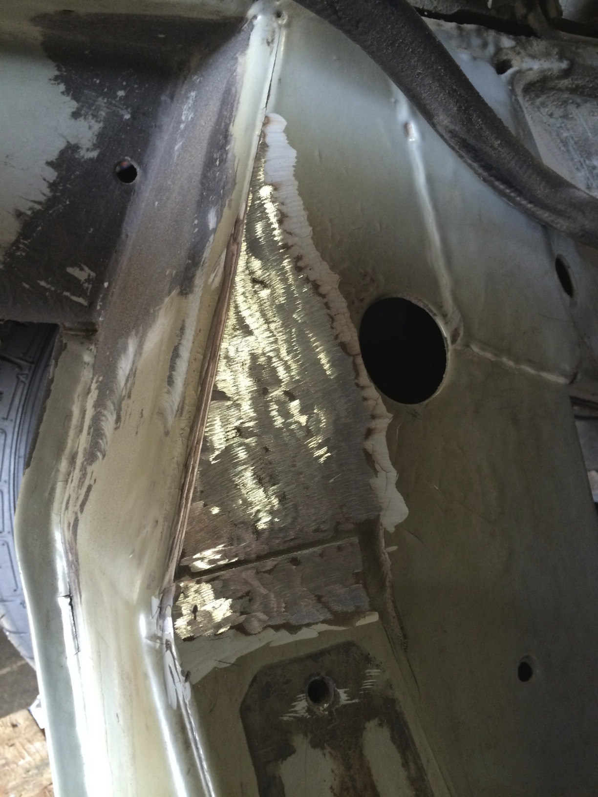 The bare clean metal after the epoxy was removed with an angle grinder.