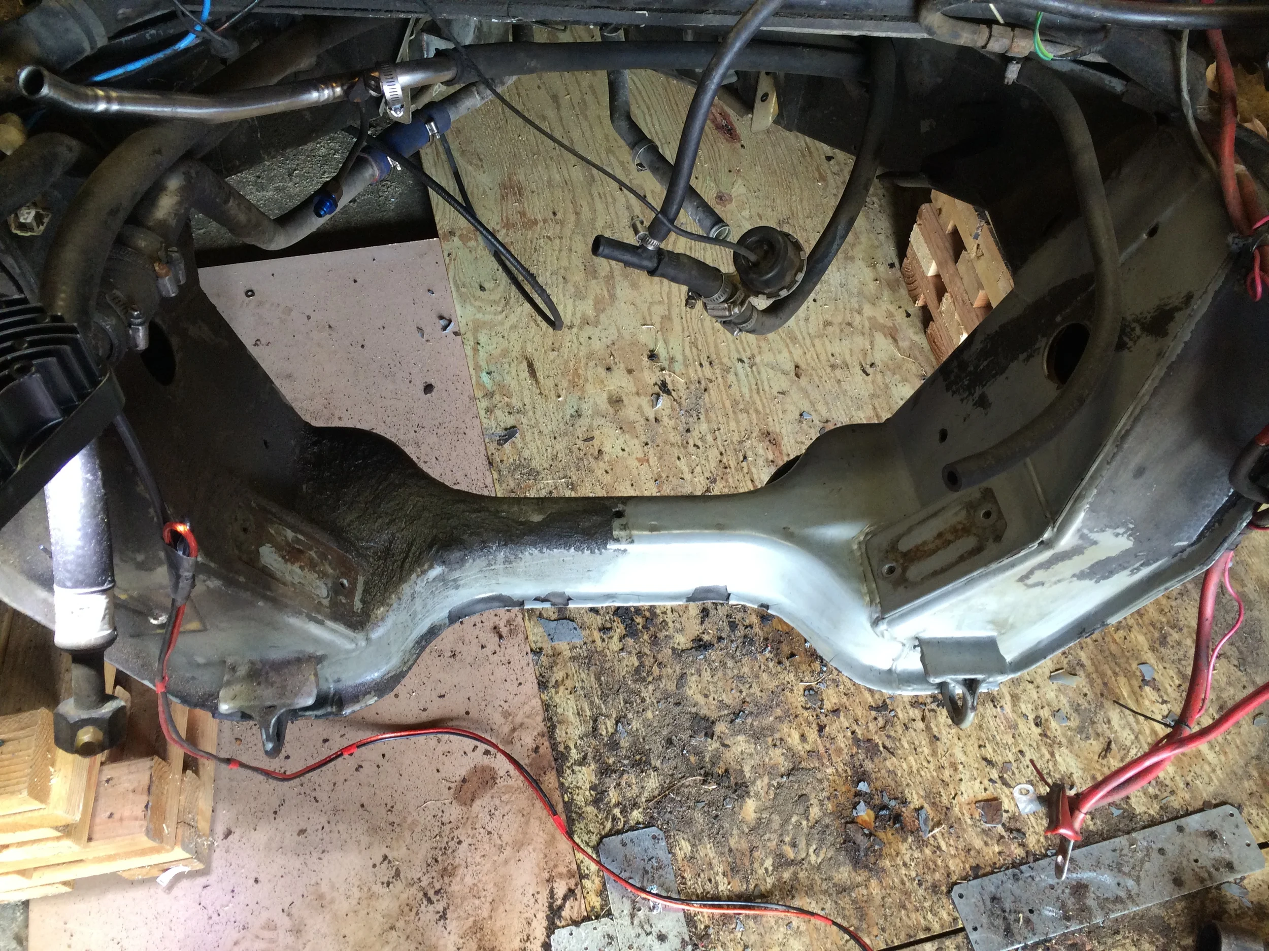 Before( left side) and after (right side) cleaning the oil off the engine cradle. The black remaining on the frame on the right is aftermarket undercoating that is reasonably well bonded to the epoxy..