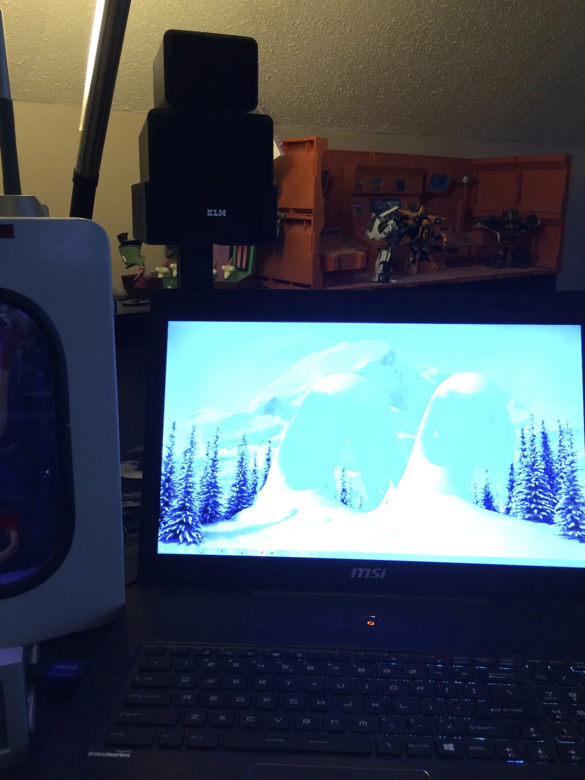 The rear left speaker stand sits behind my Windows laptop's monitor. The heigh tot the stands was chosen specifically to clear its display.