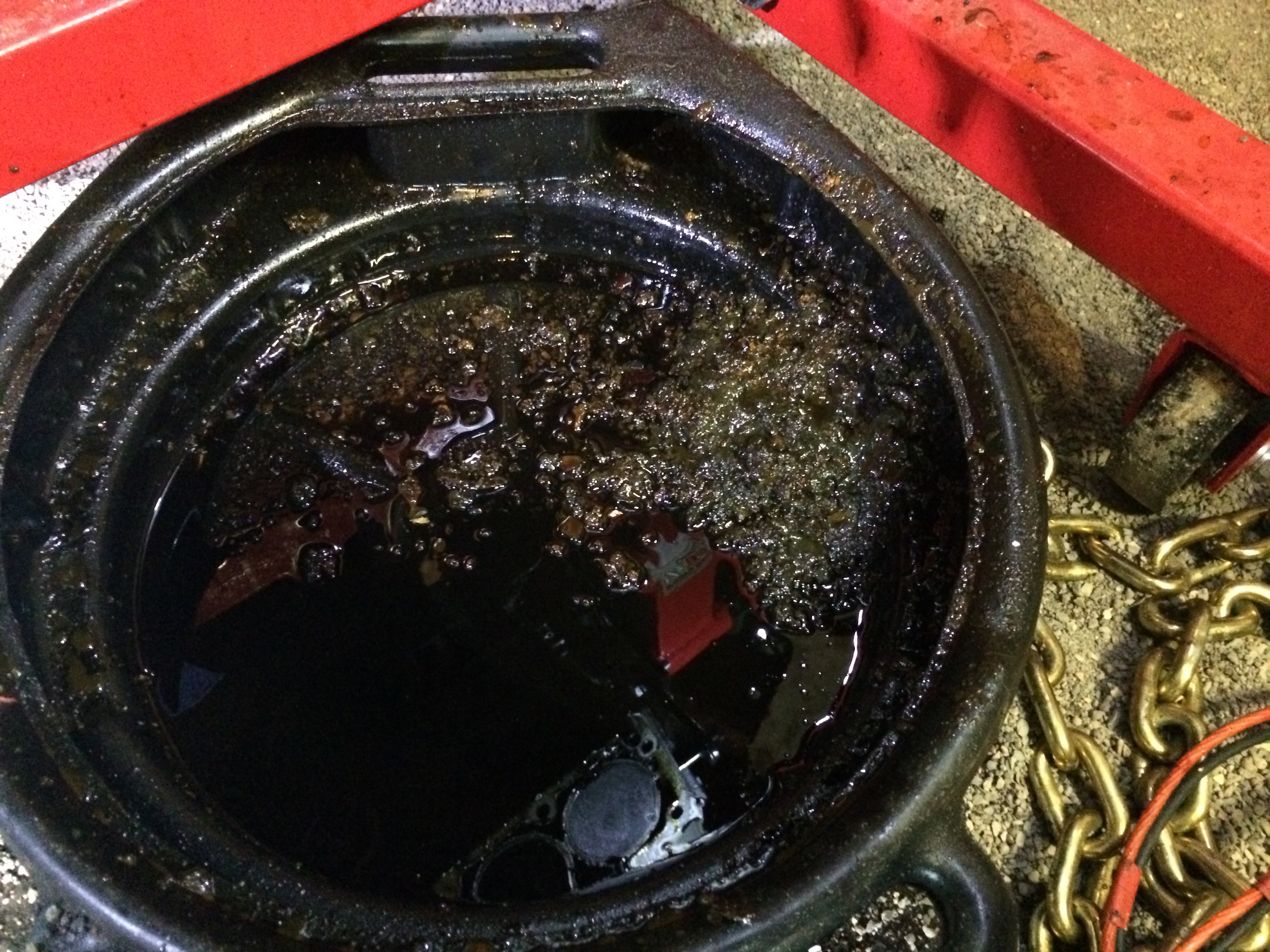 Mud that was pulled out with the pick was deposited in an oil pan. This was from only one side of the engine, and it was still quite dirty.