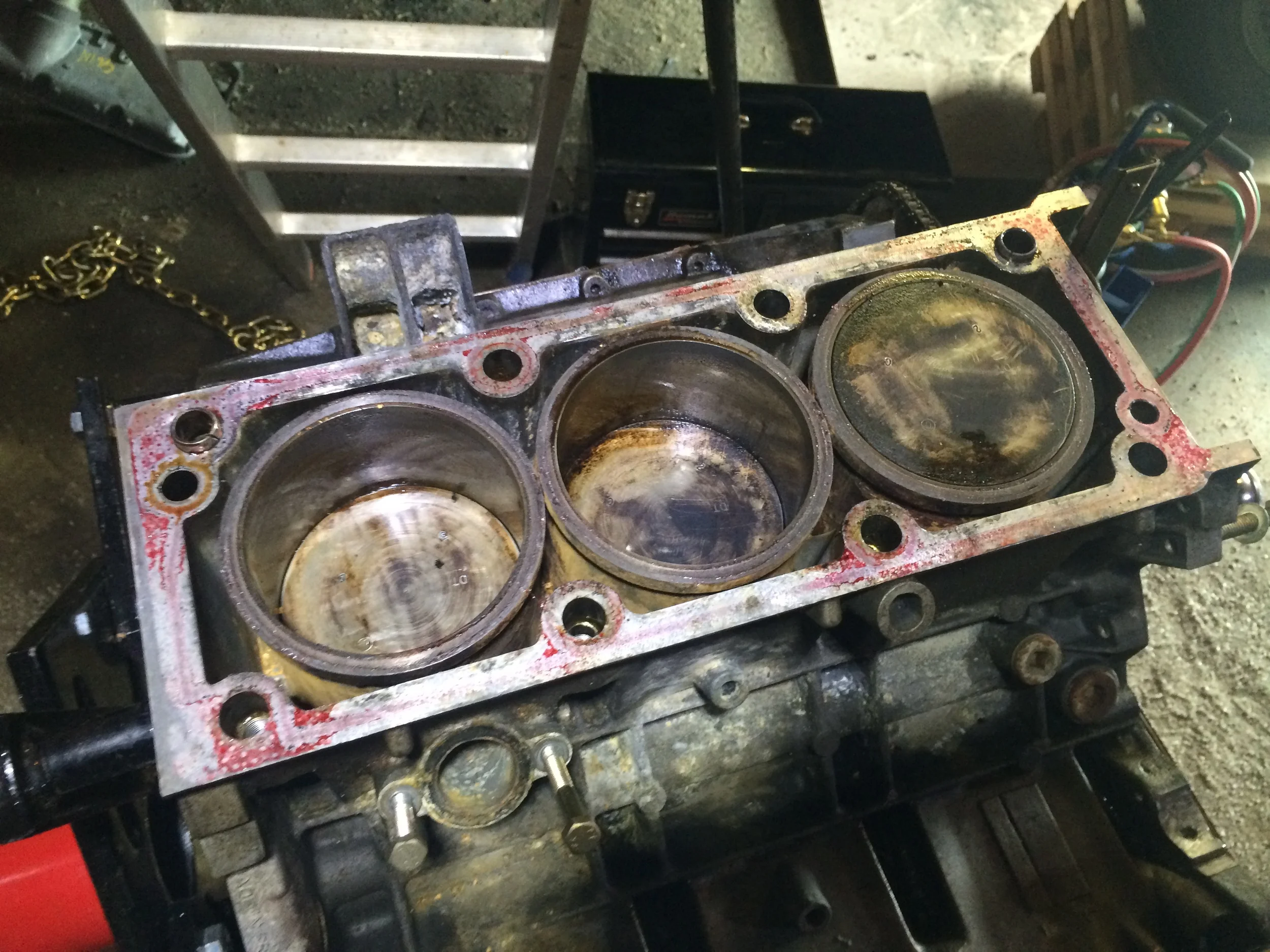 Dirty pistons. I had cleaned the leftmost one with a razor blade while it was raised, but the other two I wasn't really able to do much with as they were recessed at the time.