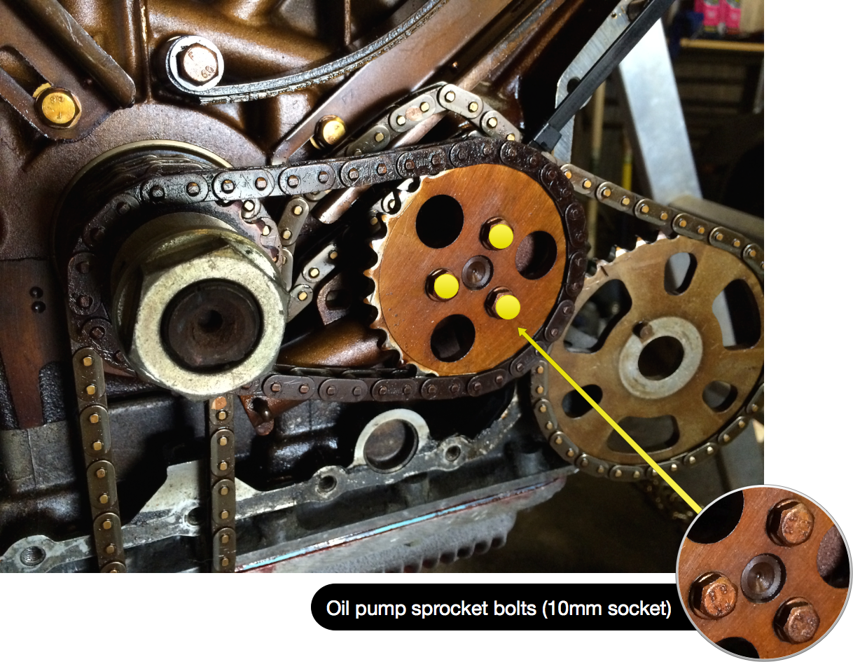 The three marked bolts are removed with a 10mm socket to remove the oil pump sprocket and chain.