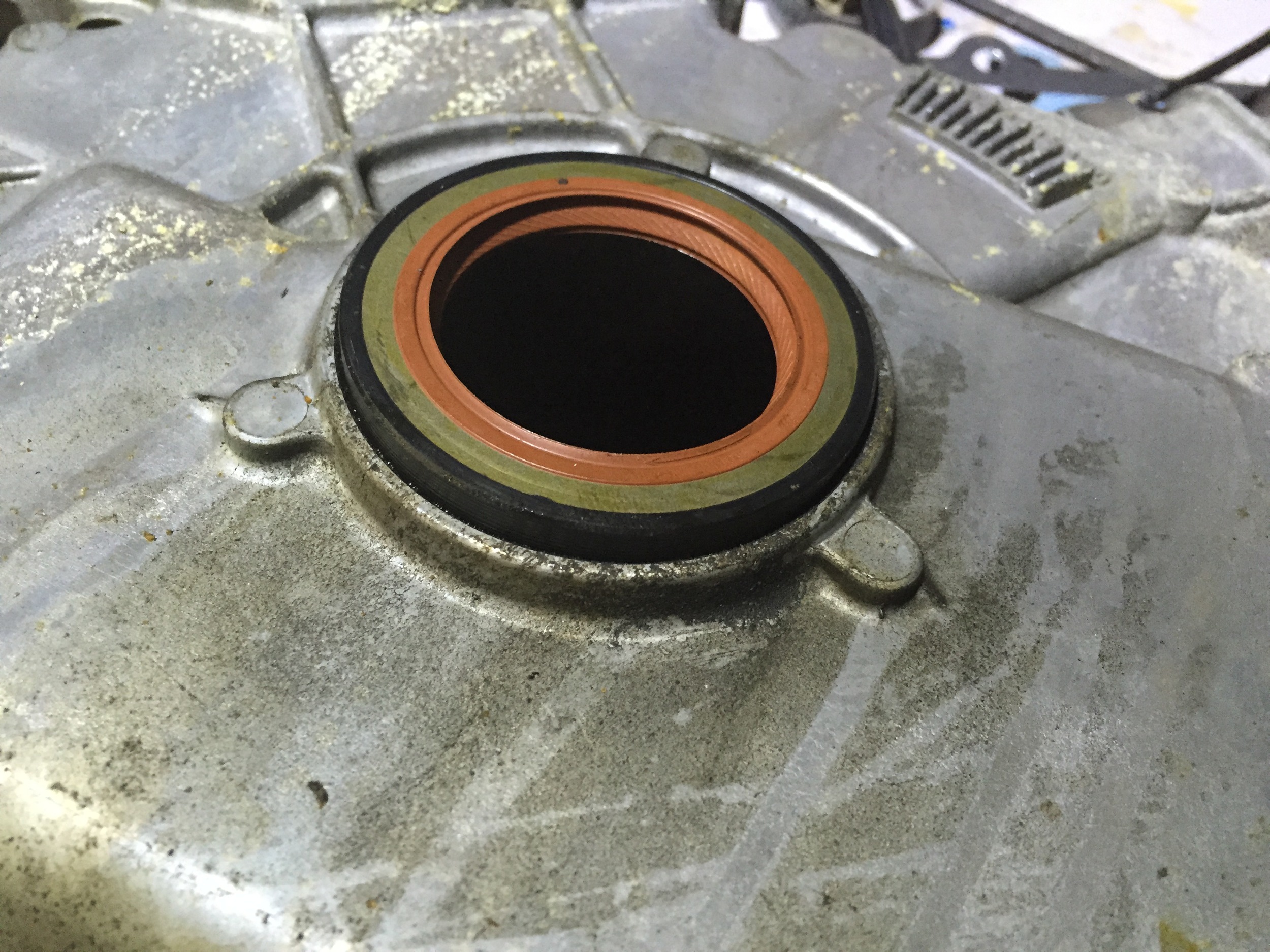 The new seal placed on top of the timing cover, but not yet installed.
