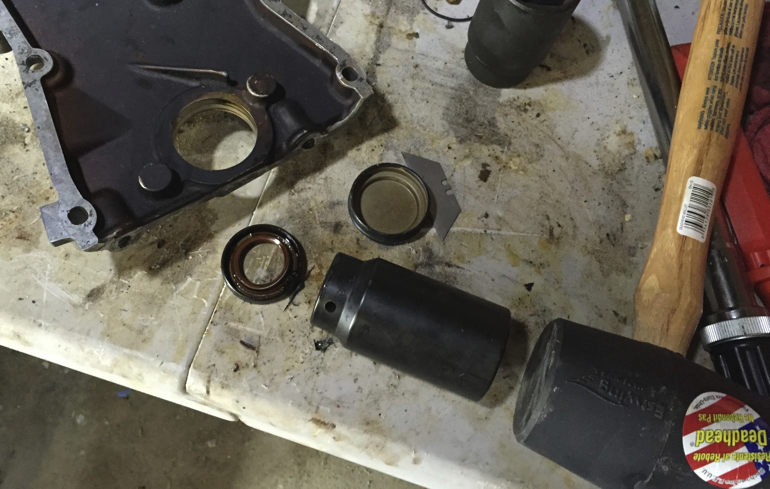 The oils oil seal, and the socket and mallet used to remove it.