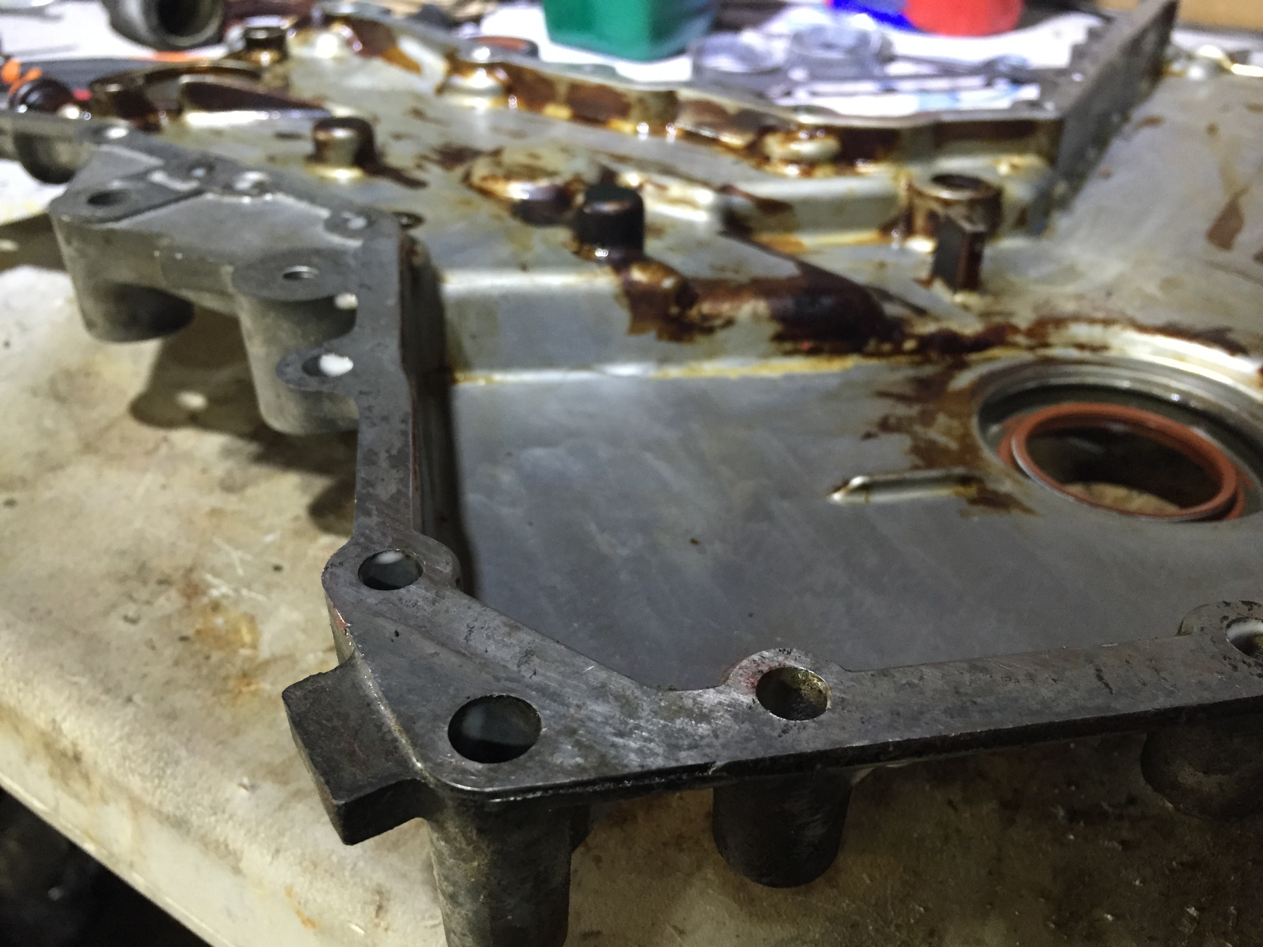 The timing cover with the gasket and oil residue removed.